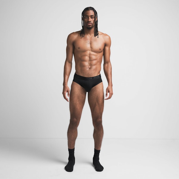 SKIMS STRETCH MENS BRIEF | OBSIDIAN ON A MODEL FRONT VIEW @ | FOCUS: 0.9, 0.1, 0.7