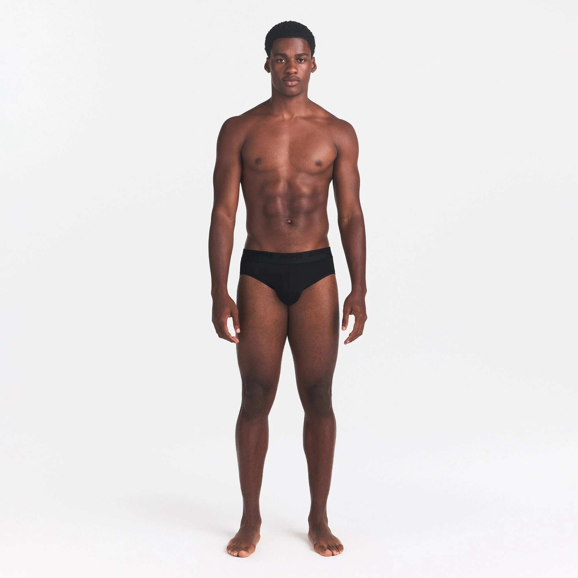 SKIMS STRETCH MENS BRIEF | OBSIDIAN ON A MODEL FRONT VIEW @ | FOCUS: 0.0, 1.0, 0.9