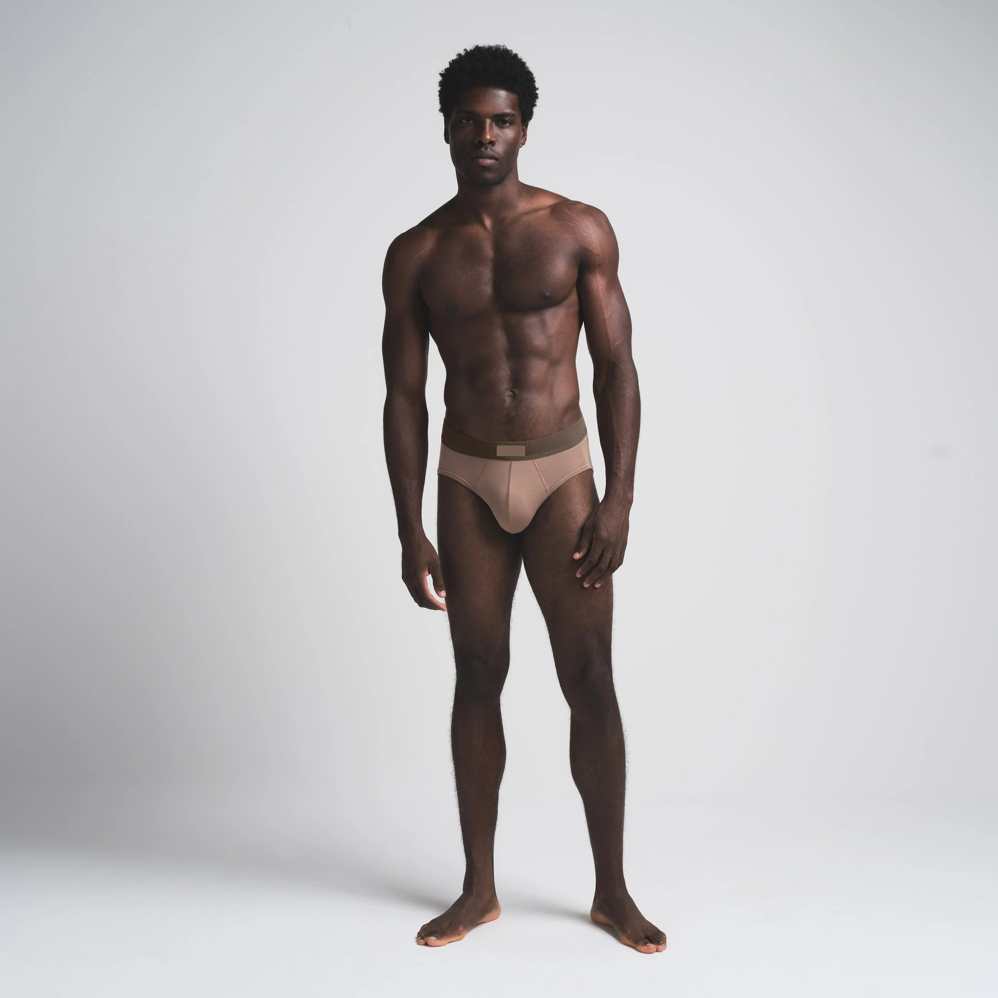 SKIMS COTTON MENS BRIEF 3-PACK | AGATE MULTI (MENS BRIEFS) ON A MODEL FRONT VIEW