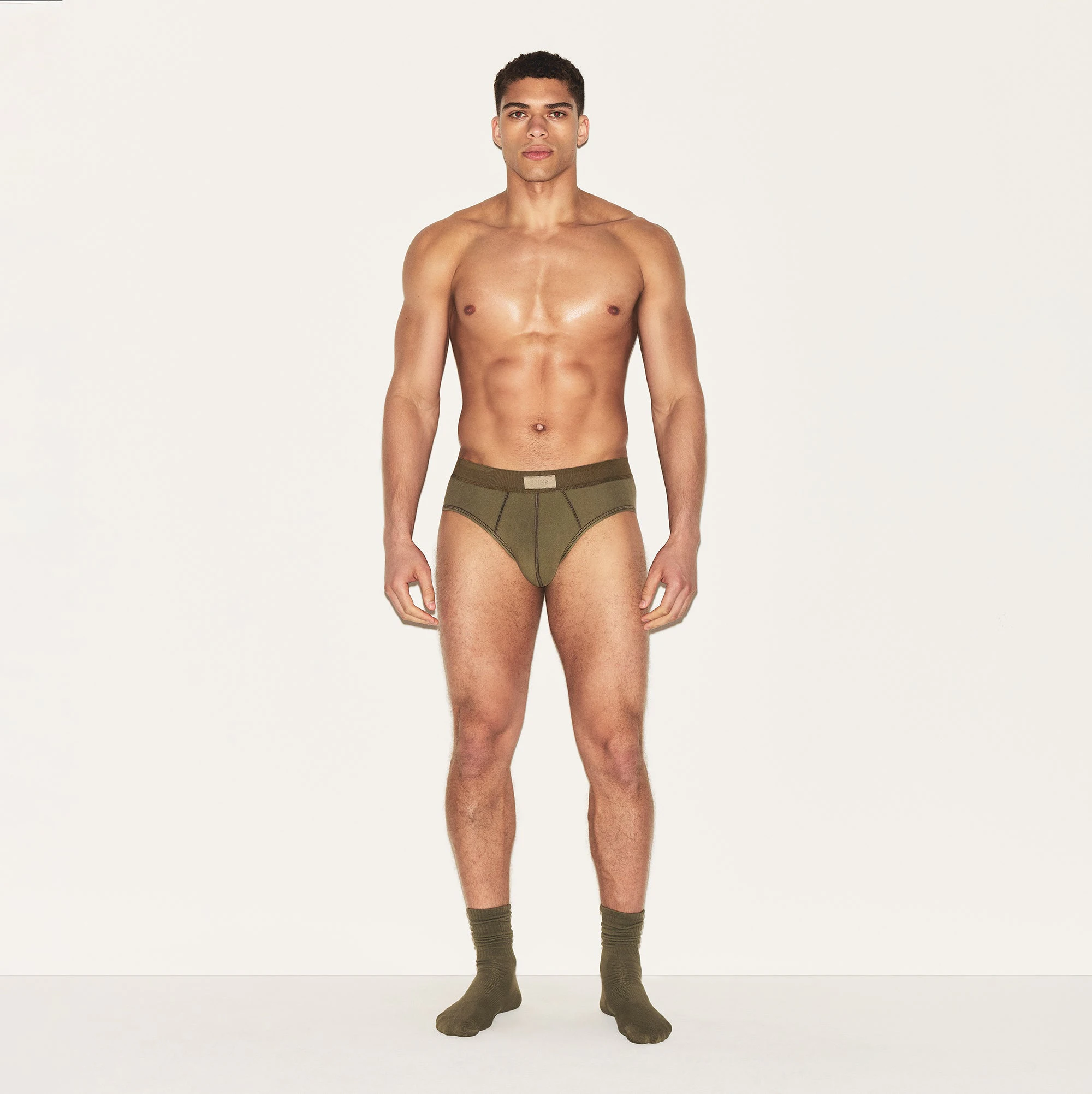 SKIMS COTTON MENS BRIEF | ARMY ON A MODEL FRONT VIEW | FOCUS: 0.0, 1.0, 0.9