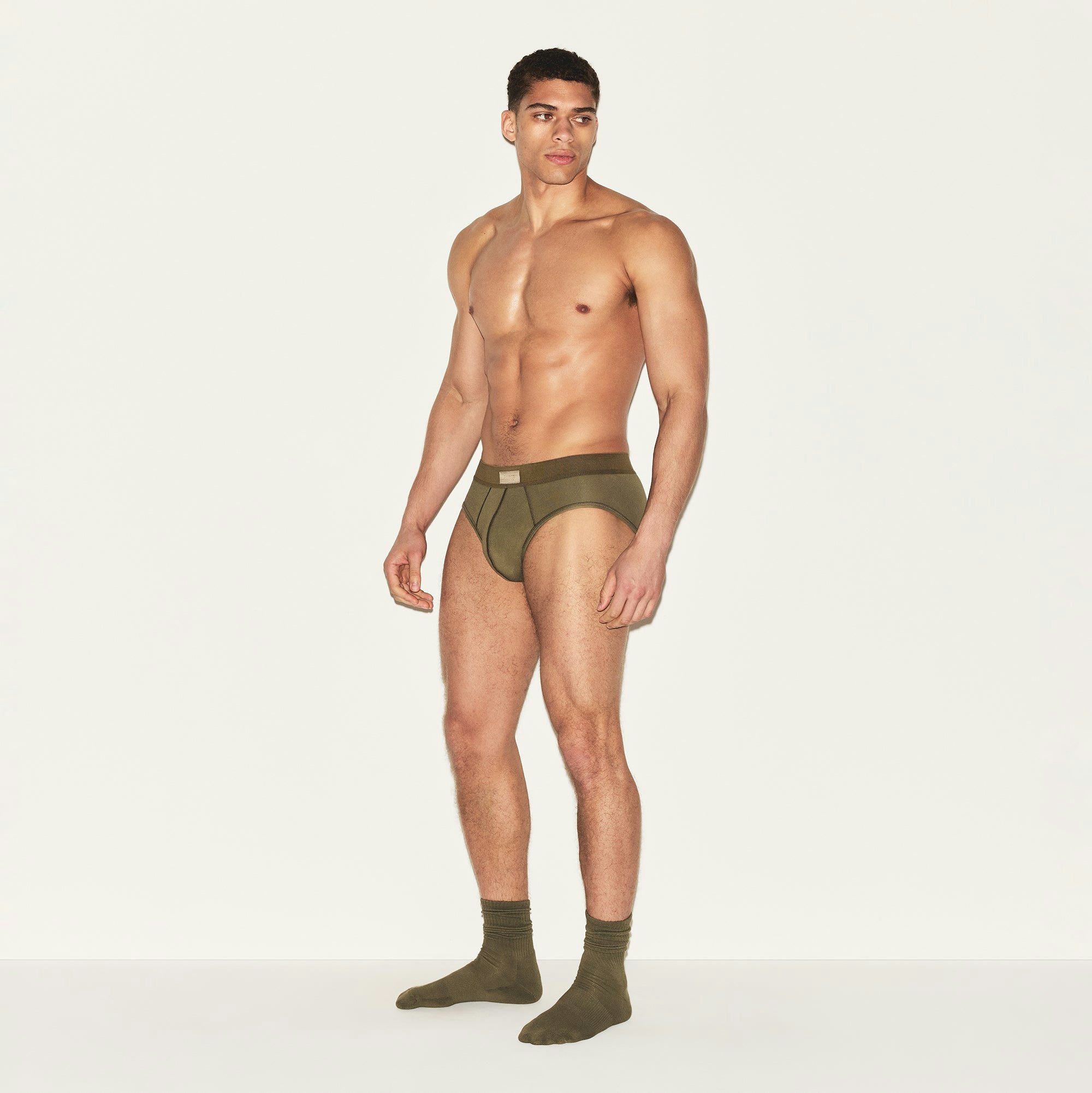 SKIMS COTTON MENS BRIEF | ARMY ON A MODEL SIDE VIEW | FOCUS: 0.0, 1.0, 0.9