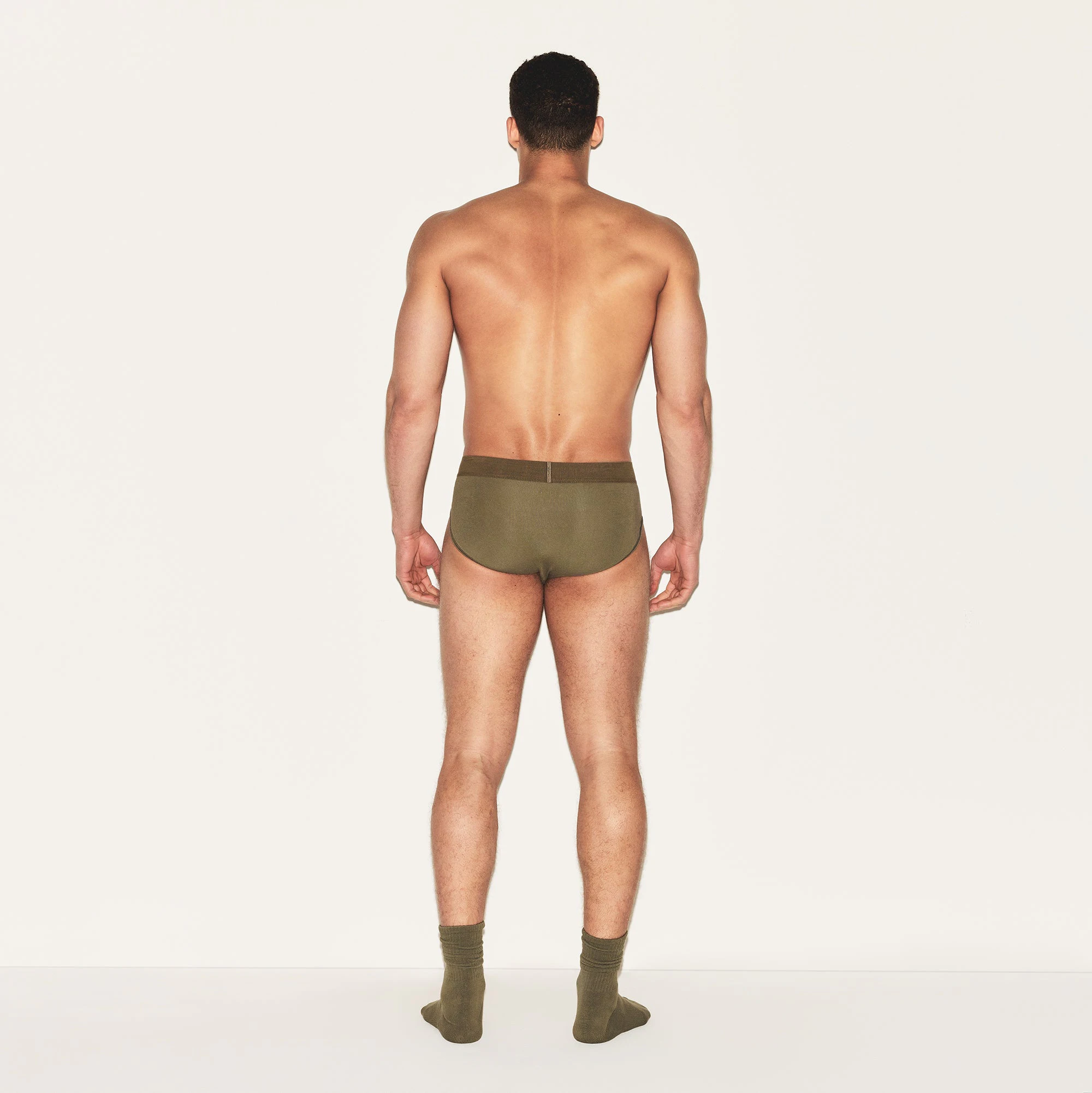 SKIMS COTTON MENS BRIEF | ARMY ON A MODEL BACK VIEW | FOCUS: 0.0, 1.0, 0.9