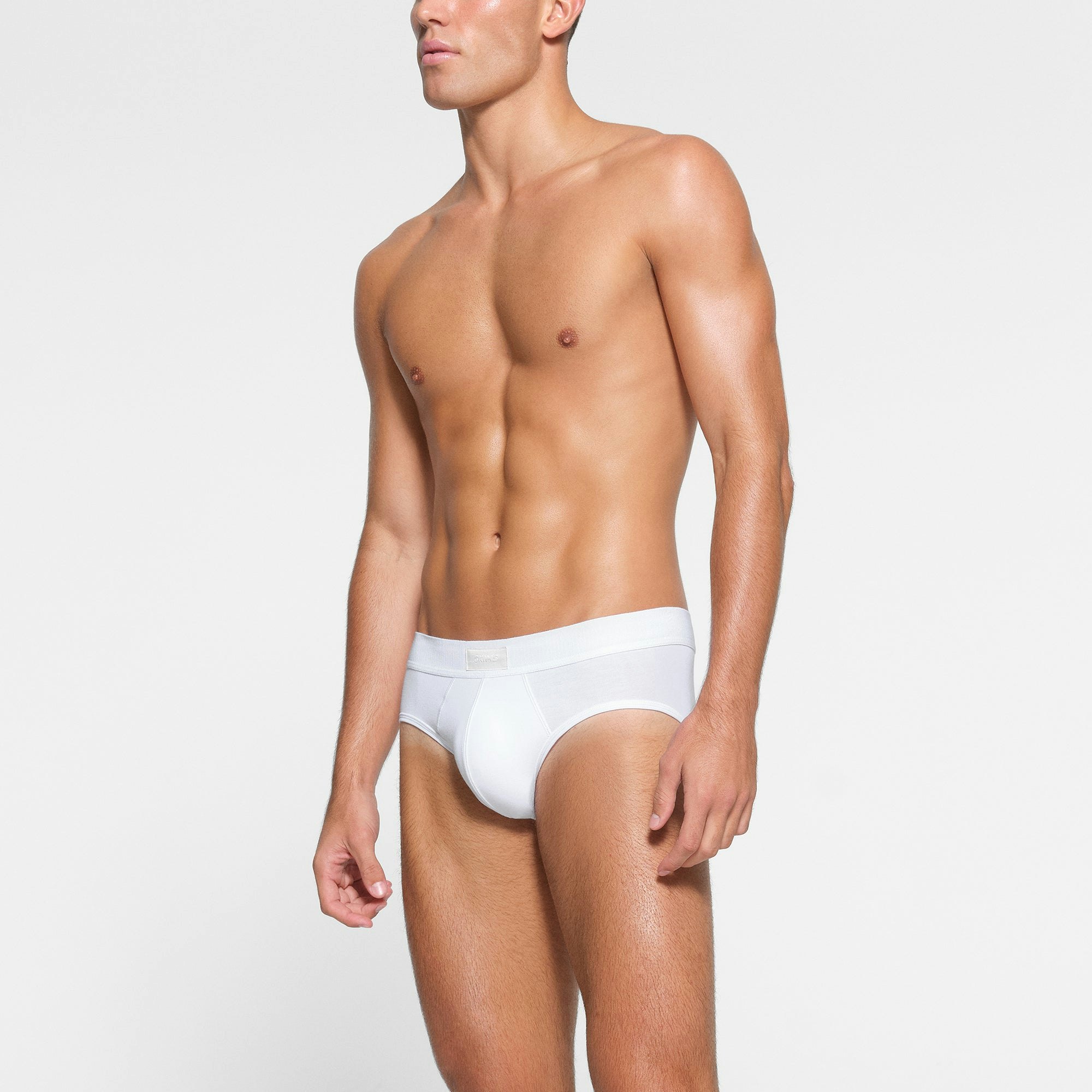 SKIMS COTTON MENS BRIEF 3-PACK WORN BY A MODEL IN SIDE VIEW