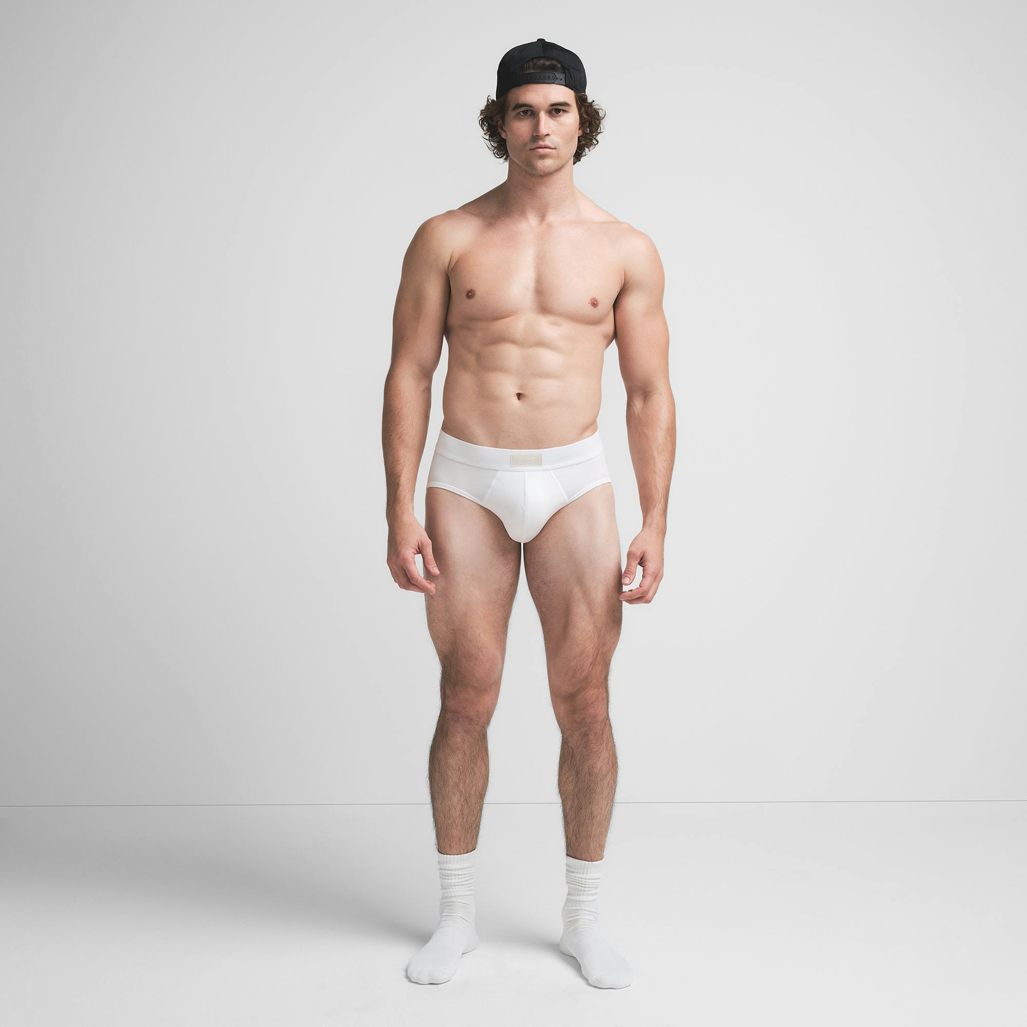 SKIMS COTTON MENS BRIEF | CHALK ON A MODEL FRONT VIEW @ | FOCUS: 0.9, 0.1, 0.7
