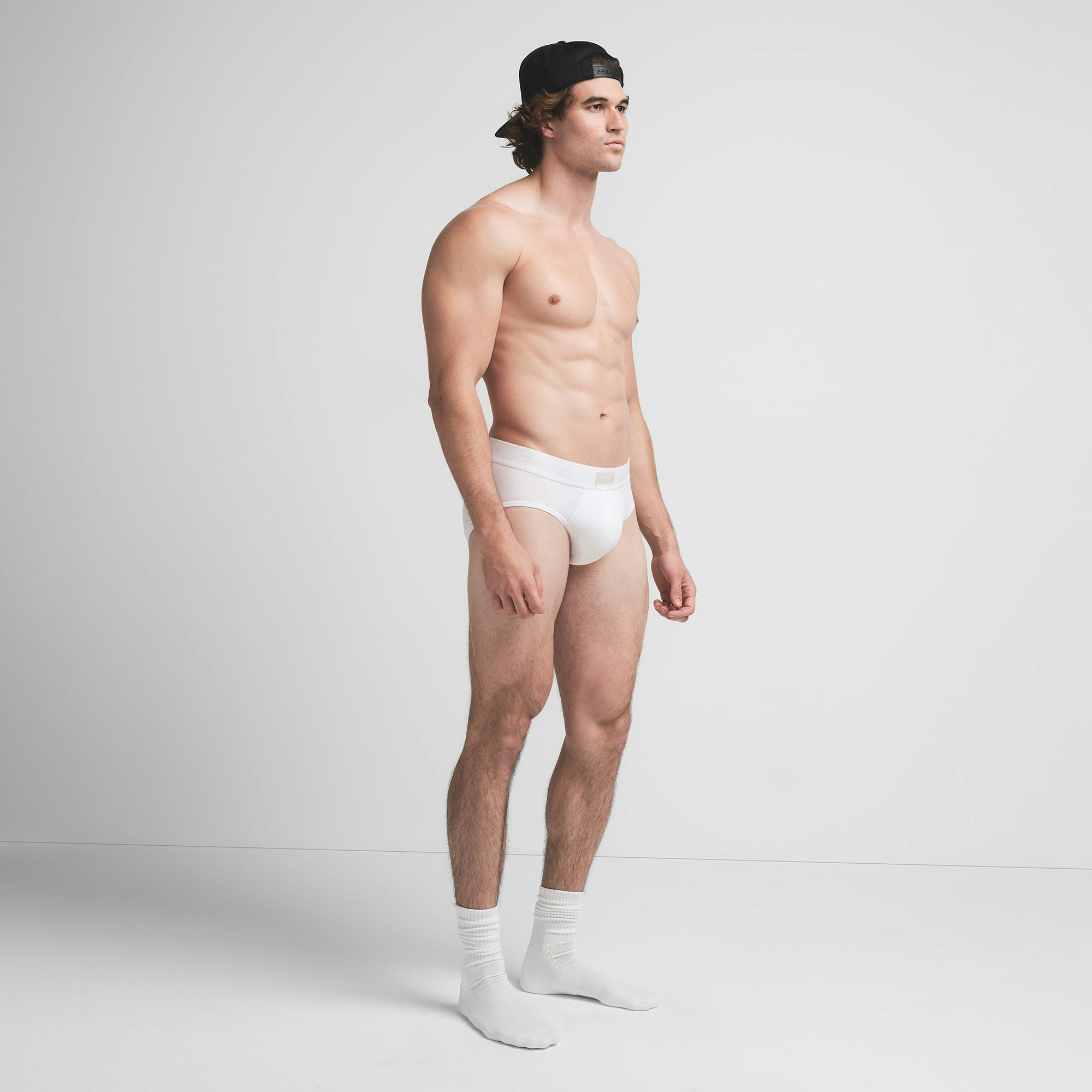 SKIMS COTTON MENS BRIEF | CHALK ON A MODEL SIDE VIEW @ | FOCUS: 0.9, 0.1, 0.7