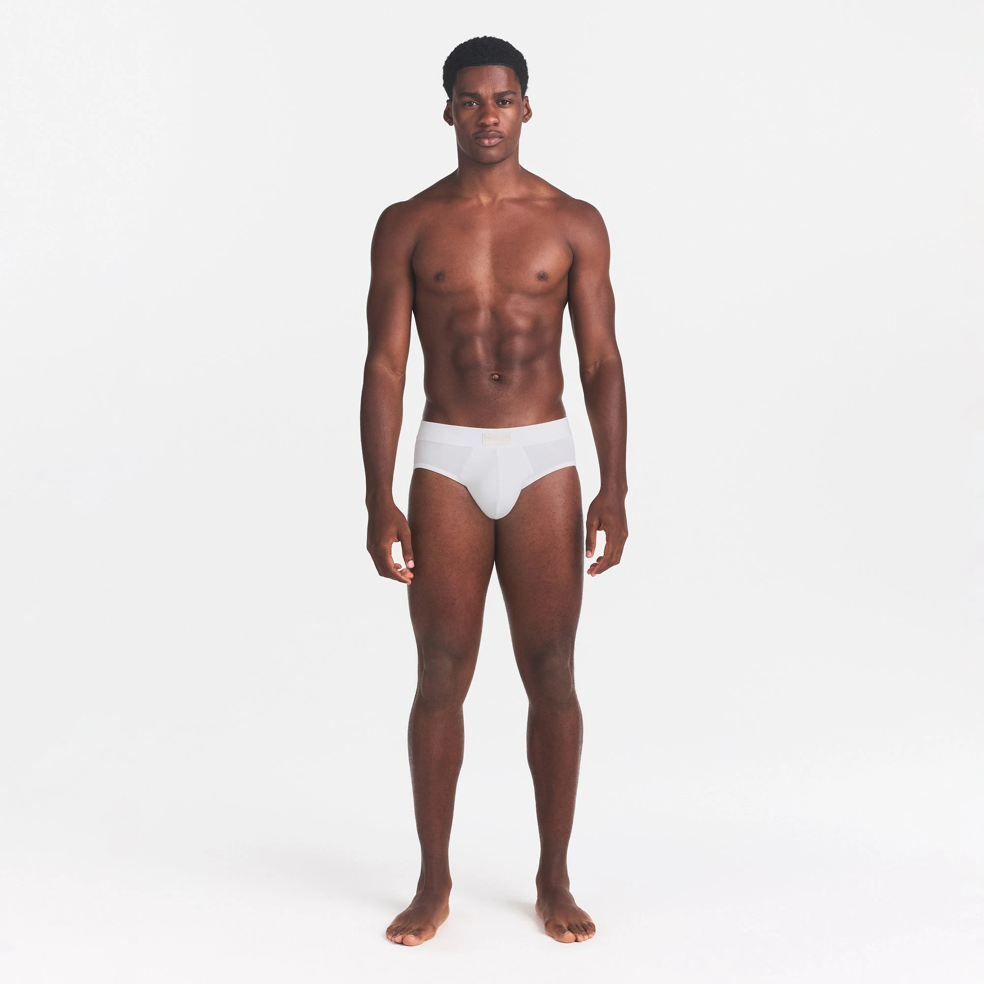 SKIMS COTTON MENS BRIEF | CHALK ON A MODEL FRONT VIEW @ | FOCUS: 0.0, 1.0, 0.9
