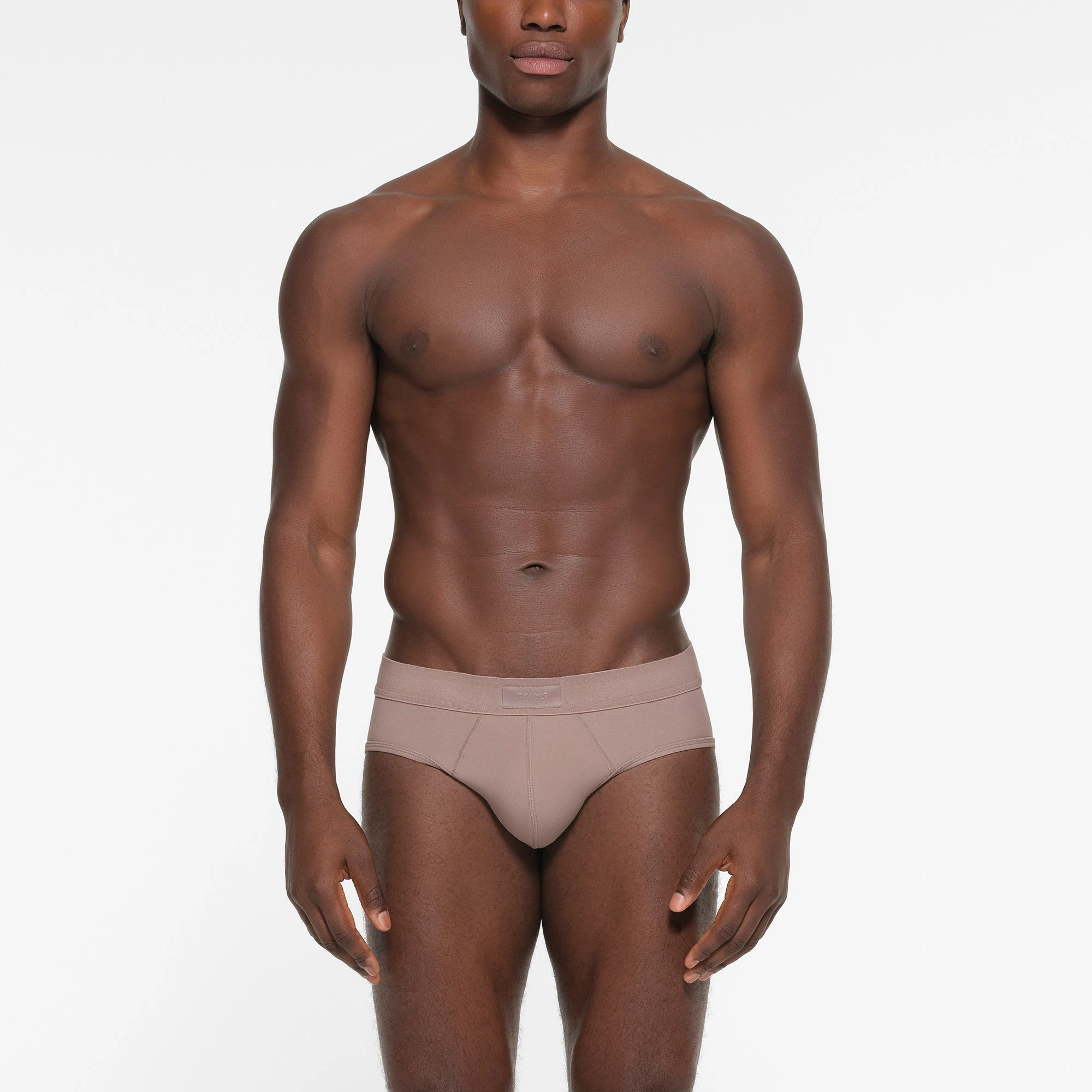 SKIMS COTTON MENS BRIEF | FAWN ON A MODEL FRONT VIEW