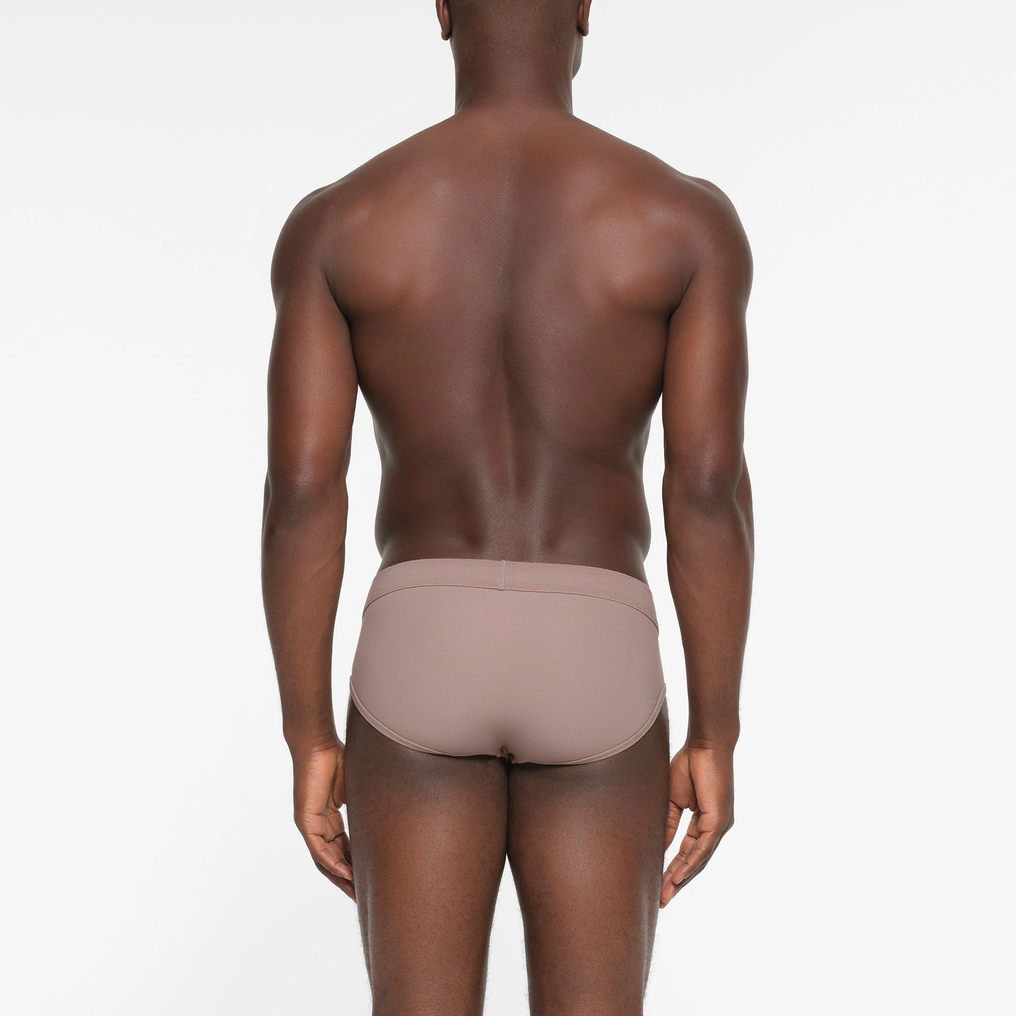 SKIMS COTTON MENS BRIEF | FAWN ON A MODEL BACK VIEW