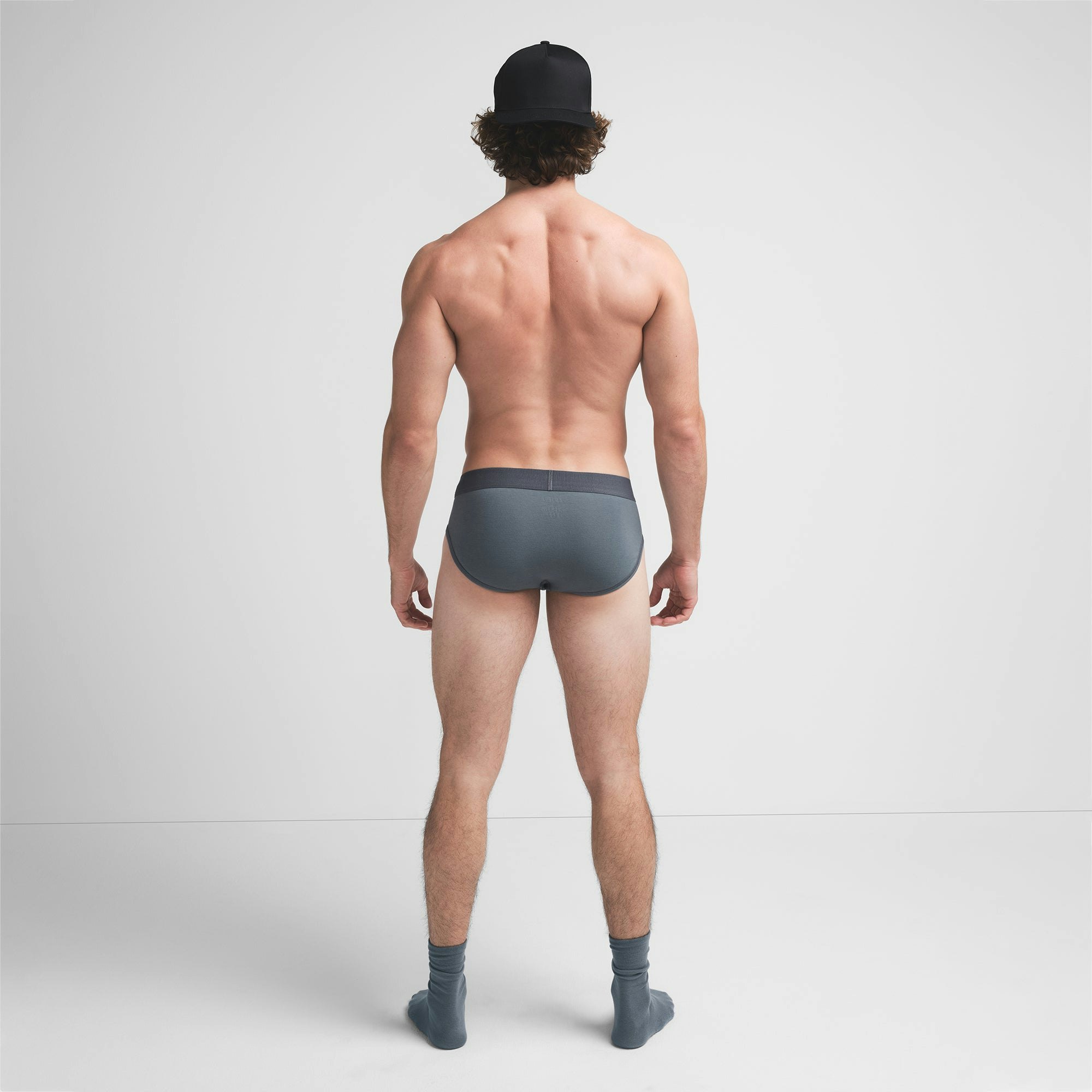 SKIMS COTTON MENS BRIEF | KYANITE ON A MODEL BACK VIEW @ | FOCUS: 0.9, 0.1, 0.7