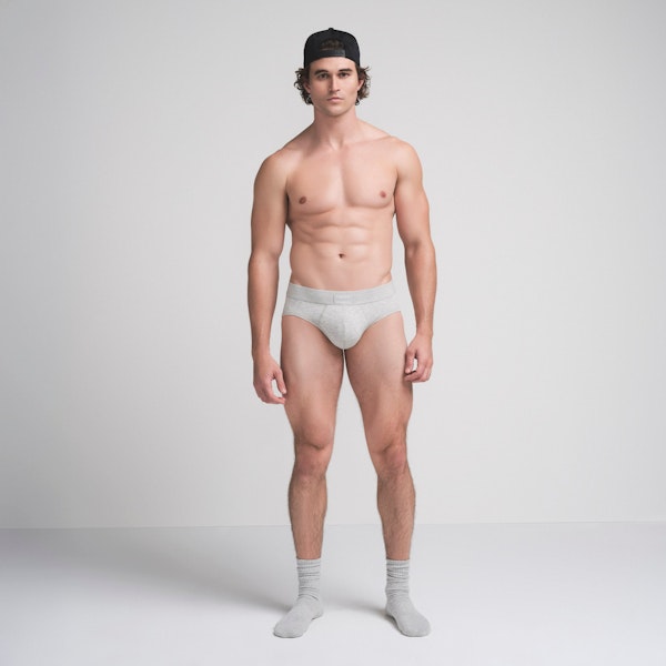 SKIMS COTTON MENS BRIEF | LIGHT HEATHER GREY ON A MODEL FRONT VIEW @ | FOCUS: 0.9, 0.1, 0.7