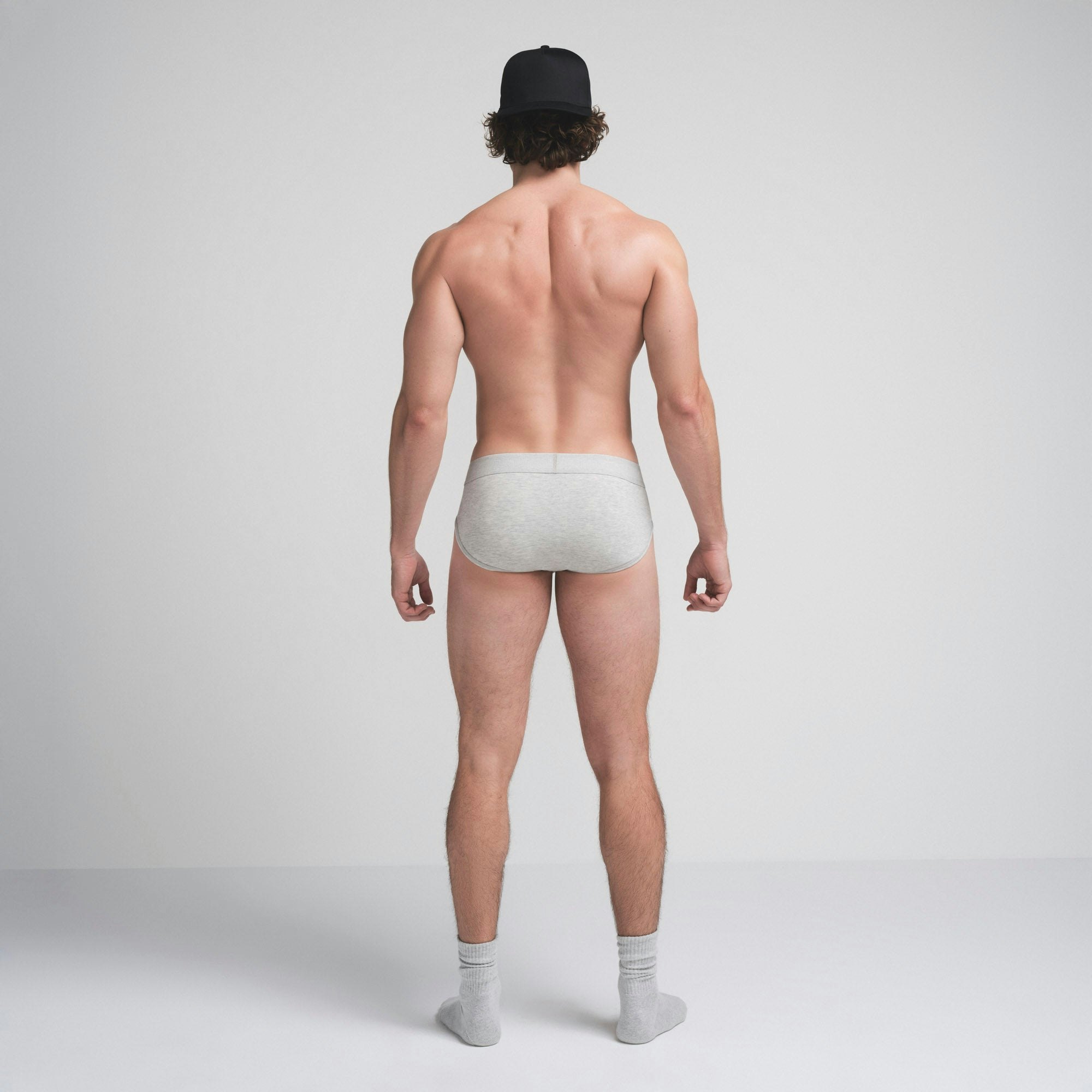 SKIMS COTTON MENS BRIEF | LIGHT HEATHER GREY ON A MODEL SIDE VIEW @ | FOCUS: 0.9, 0.1, 0.7