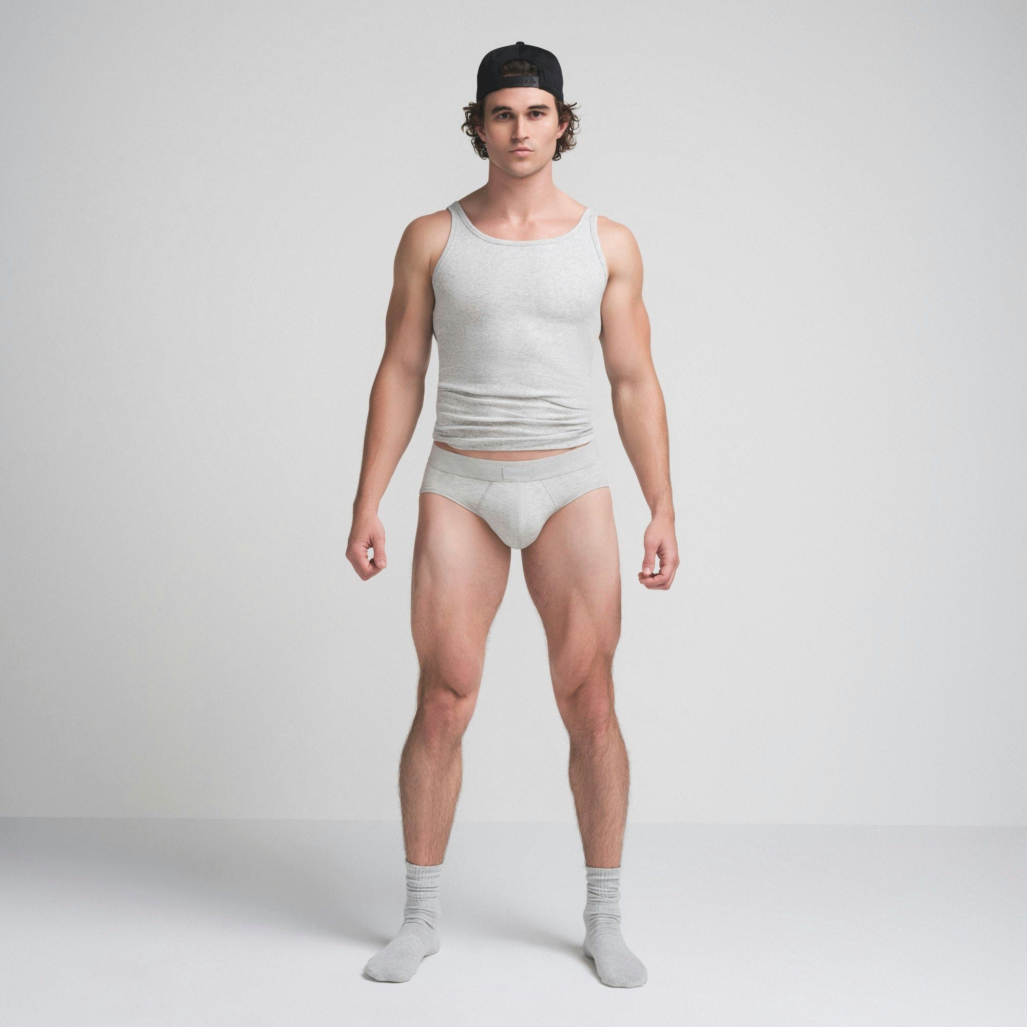 SKIMS COTTON MENS BRIEF | LIGHT HEATHER GREY ON A MODEL FRONT VIEW @ | FOCUS: 0.9, 0.1, 0.7