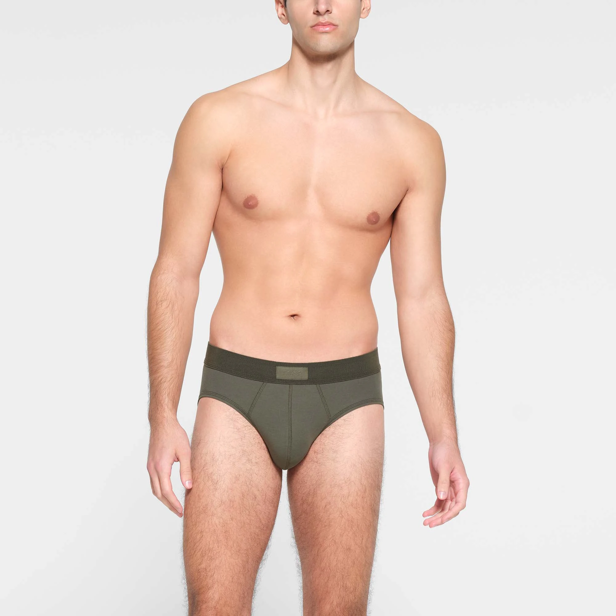 SKIMS COTTON MENS BRIEF  ON A MODEL FRONT VIEW