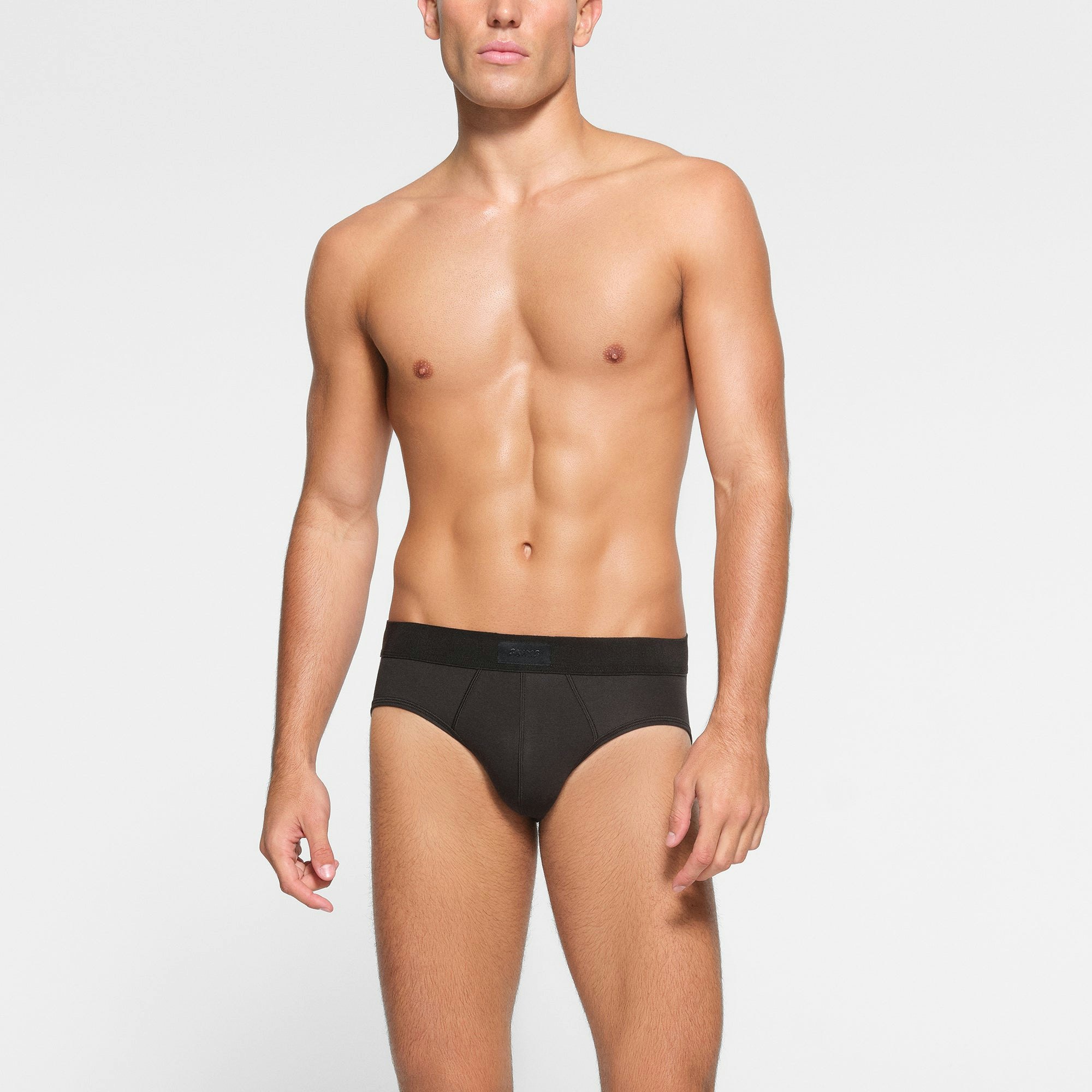 SKIMS COTTON MENS BRIEF 3-PACK WORN BY A MODEL IN FRONT VIEW