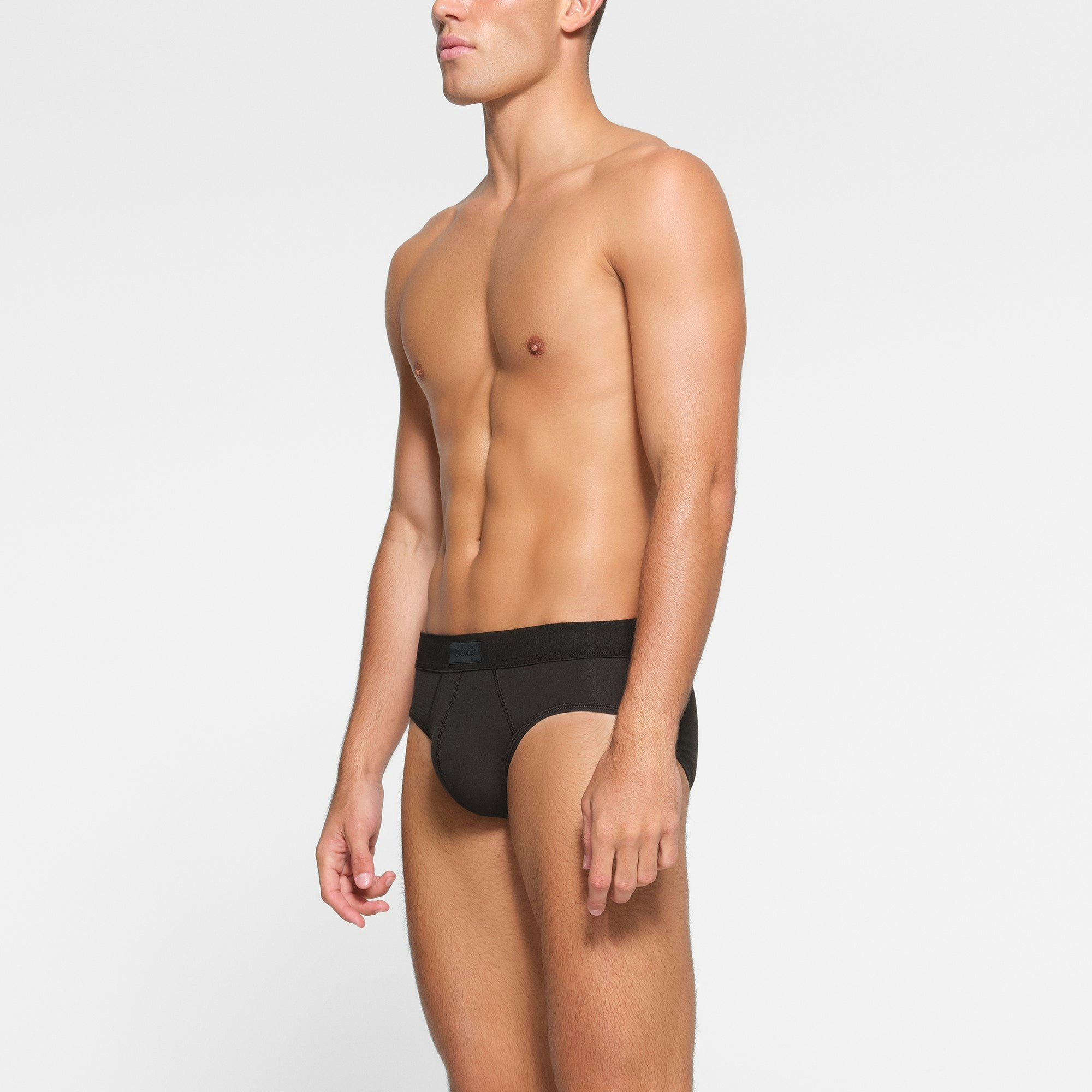 SKIMS COTTON MENS BRIEF 3-PACK WORN BY A MODEL IN SIDE VIEW
