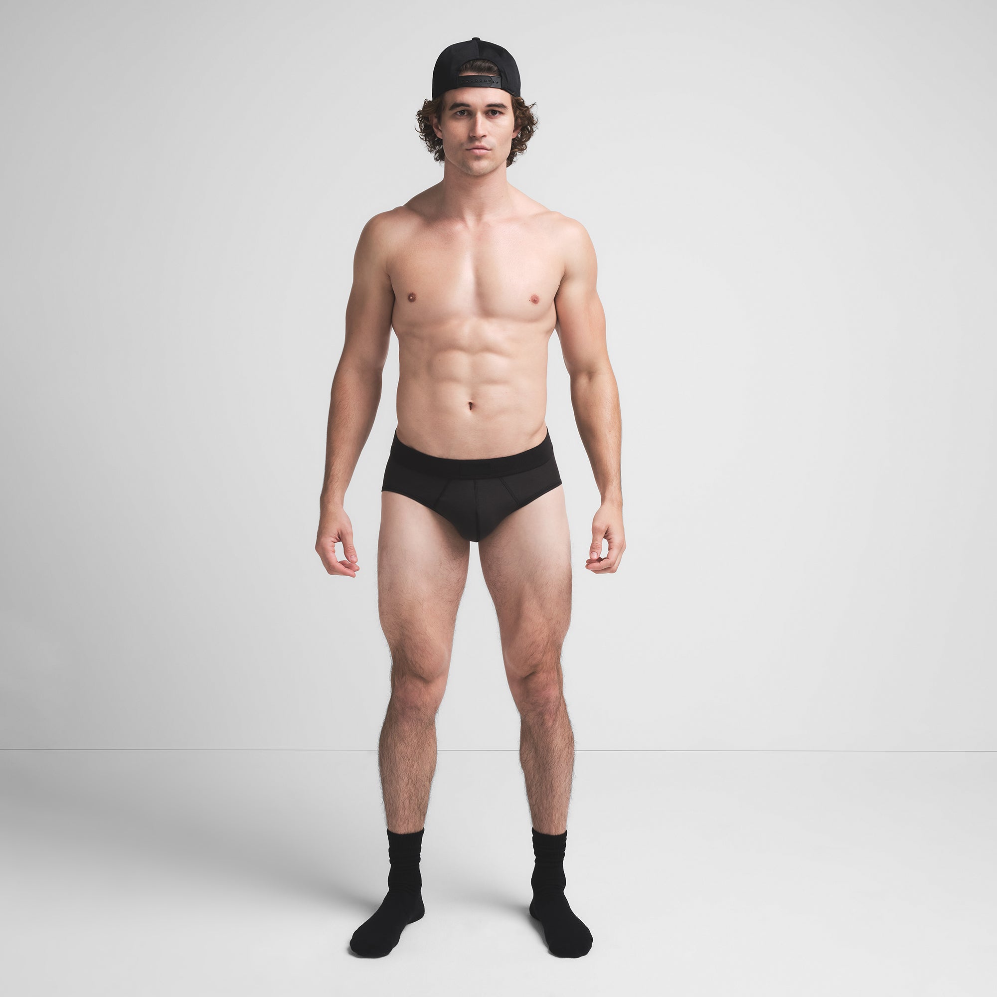 SKIMS COTTON MENS BRIEF | ONYX ON A MODEL FRONT VIEW @ | FOCUS: 0.9, 0.1, 0.7