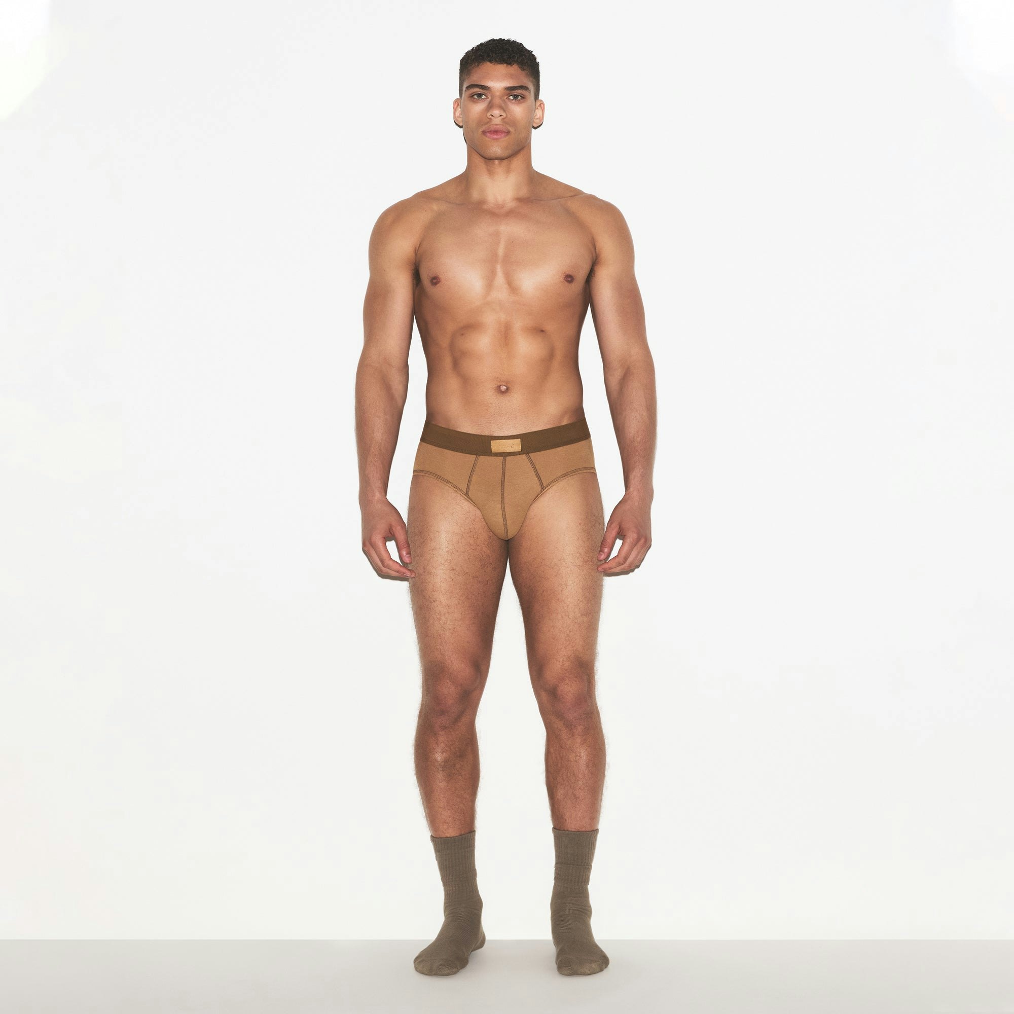 SKIMS COTTON MENS BRIEF | RUSSET ON A MODEL FRONT VIEW | FOCUS: 0.0, 1.0, 0.9