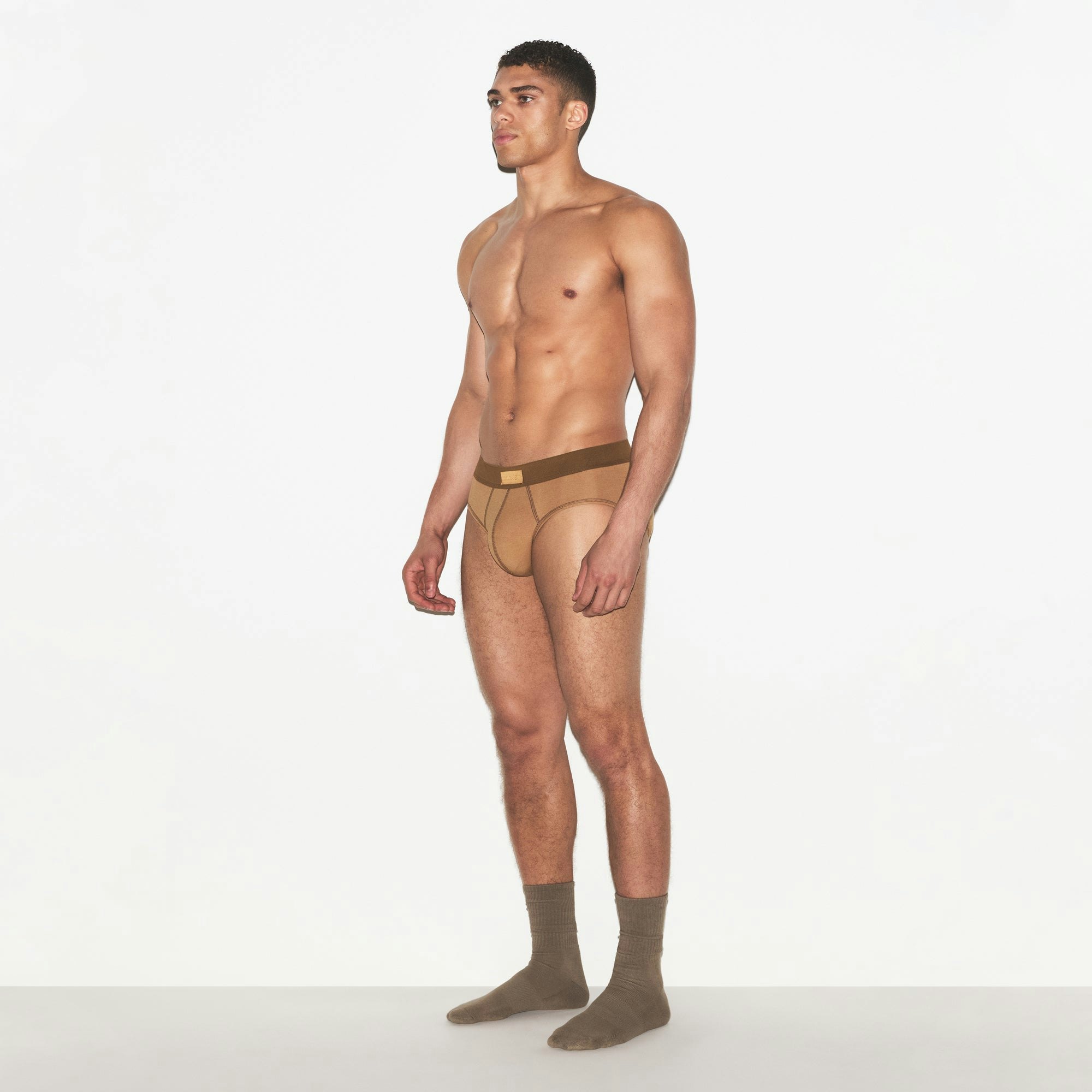 SKIMS COTTON MENS BRIEF | RUSSET ON A MODEL FRONT VIEW | FOCUS: 0.0, 1.0, 0.9