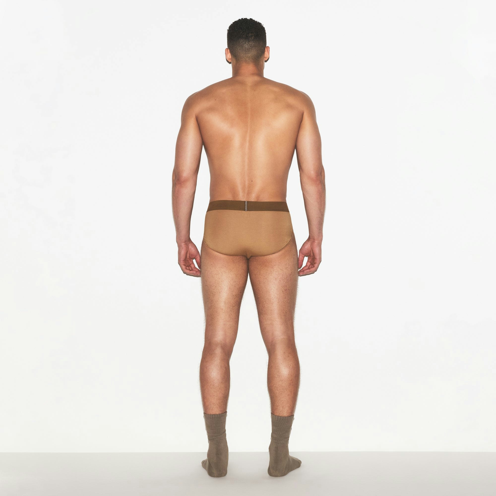SKIMS COTTON MENS BRIEF | RUSSET ON A MODEL FRONT VIEW | FOCUS: 0.0, 1.0, 0.9