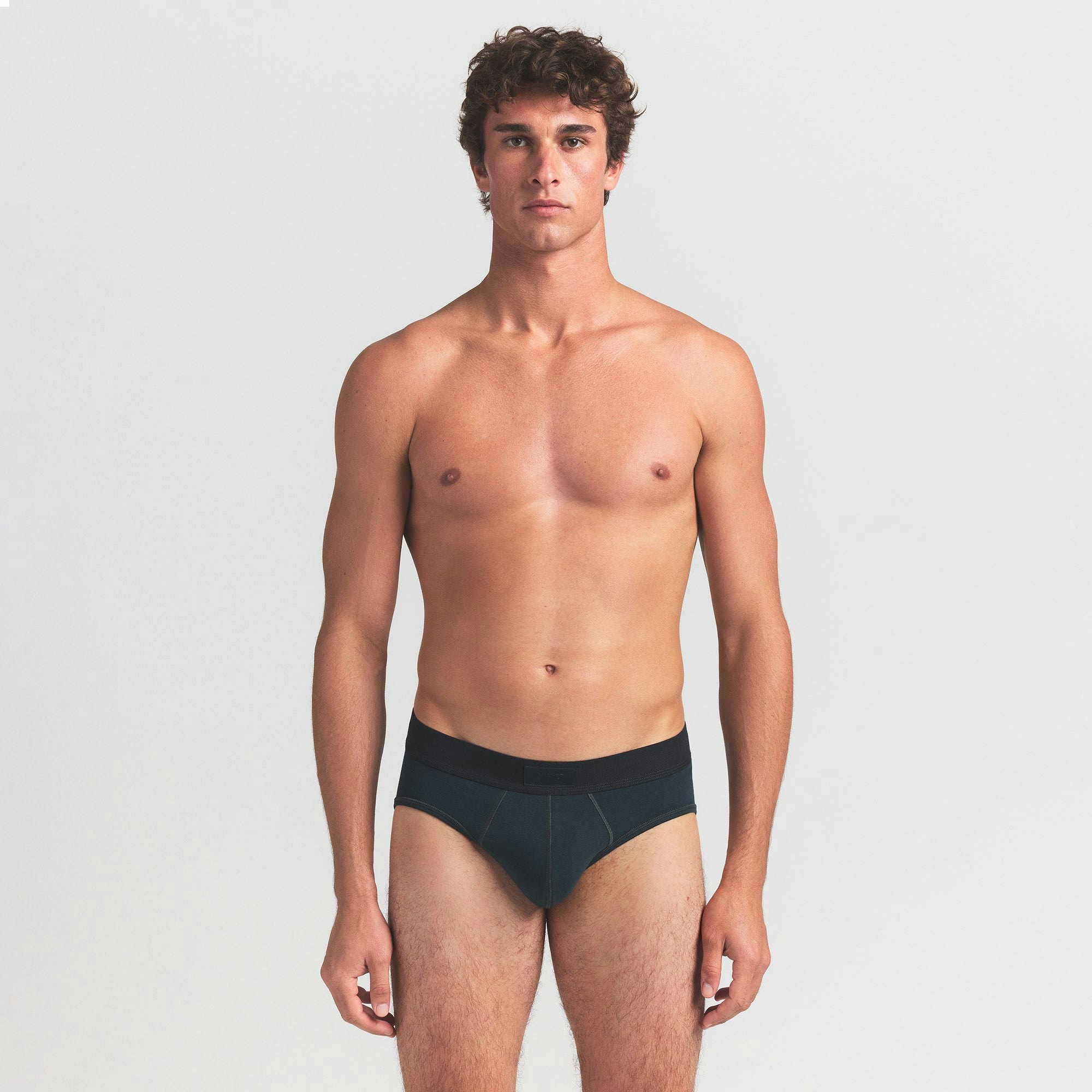 SKIMS COTTON MENS BRIEF | VERDANT ON A MODEL FRONT VIEW @ | FOCUS: 0.0, 1.0, 0.9