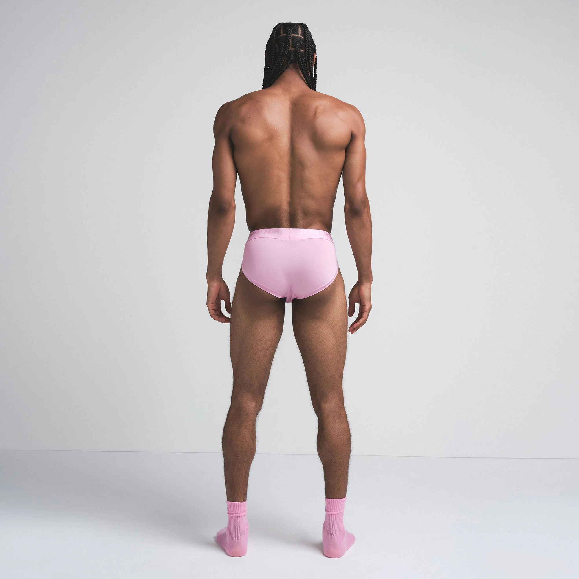 SKIMS STRETCH MENS BRIEF 3-PACK | BUBBLEGUM MIRROR MULTI ON A MODEL SIDE VIEW | FOCUS: 0.0, 1.0, 0.9