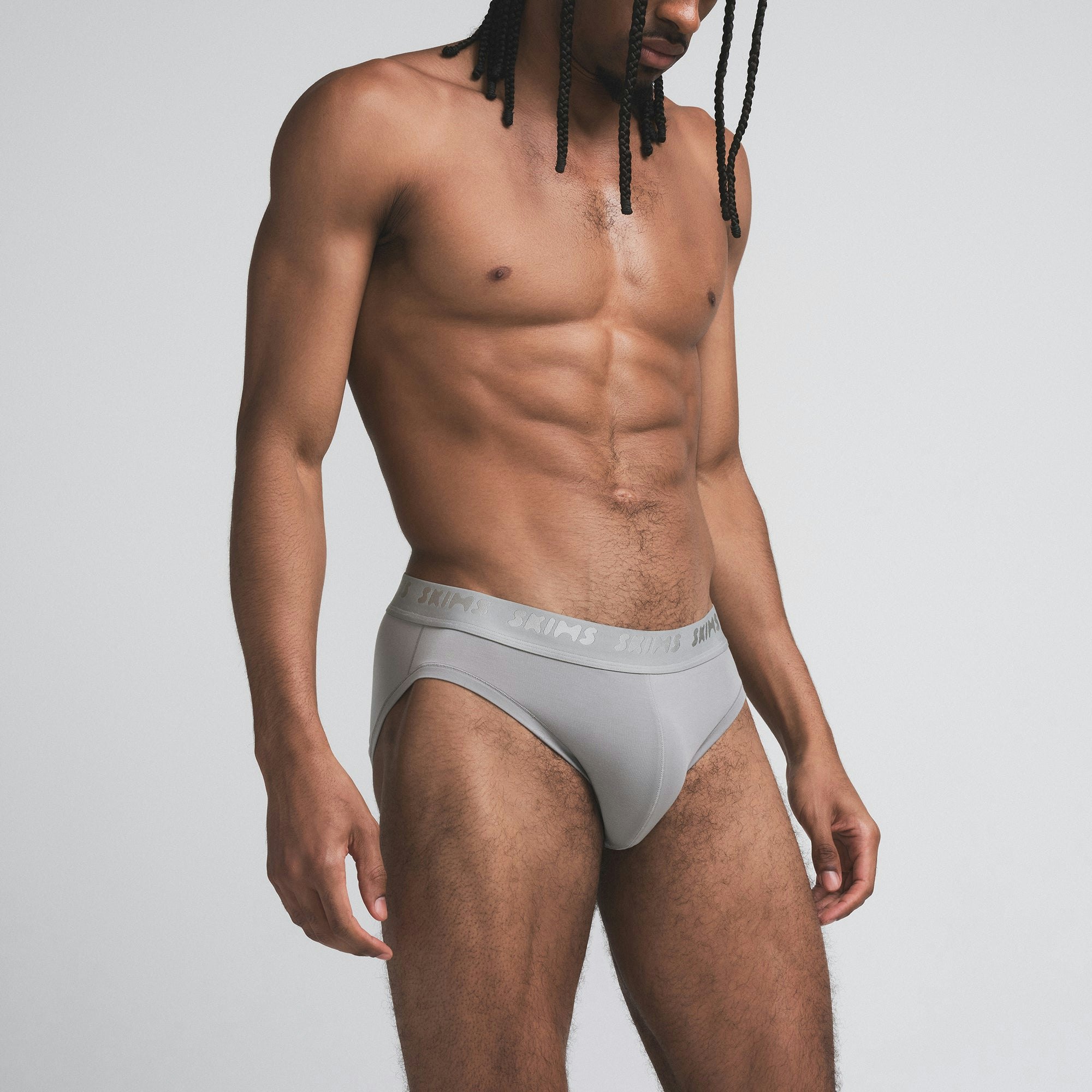 SKIMS STRETCH MENS BRIEF 3-PACK | BUBBLEGUM MIRROR MULTI ON A MODEL SIDE VIEW | FOCUS: 0.0, 1.0, 0.9