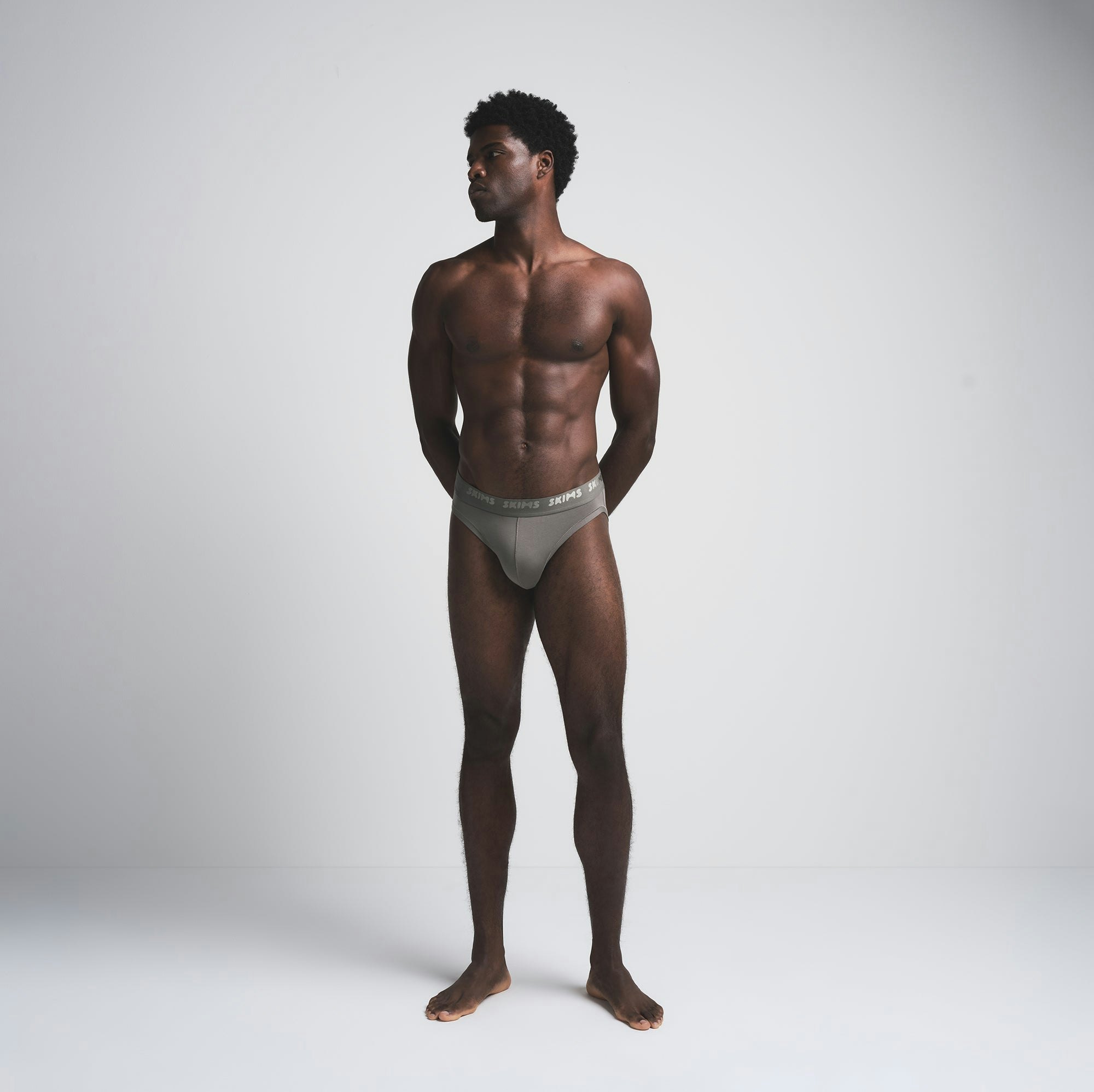 SKIMS STRETCH MENS BRIEF 3-PACK | BRICK MULTI ON A MODEL FRONT VIEW