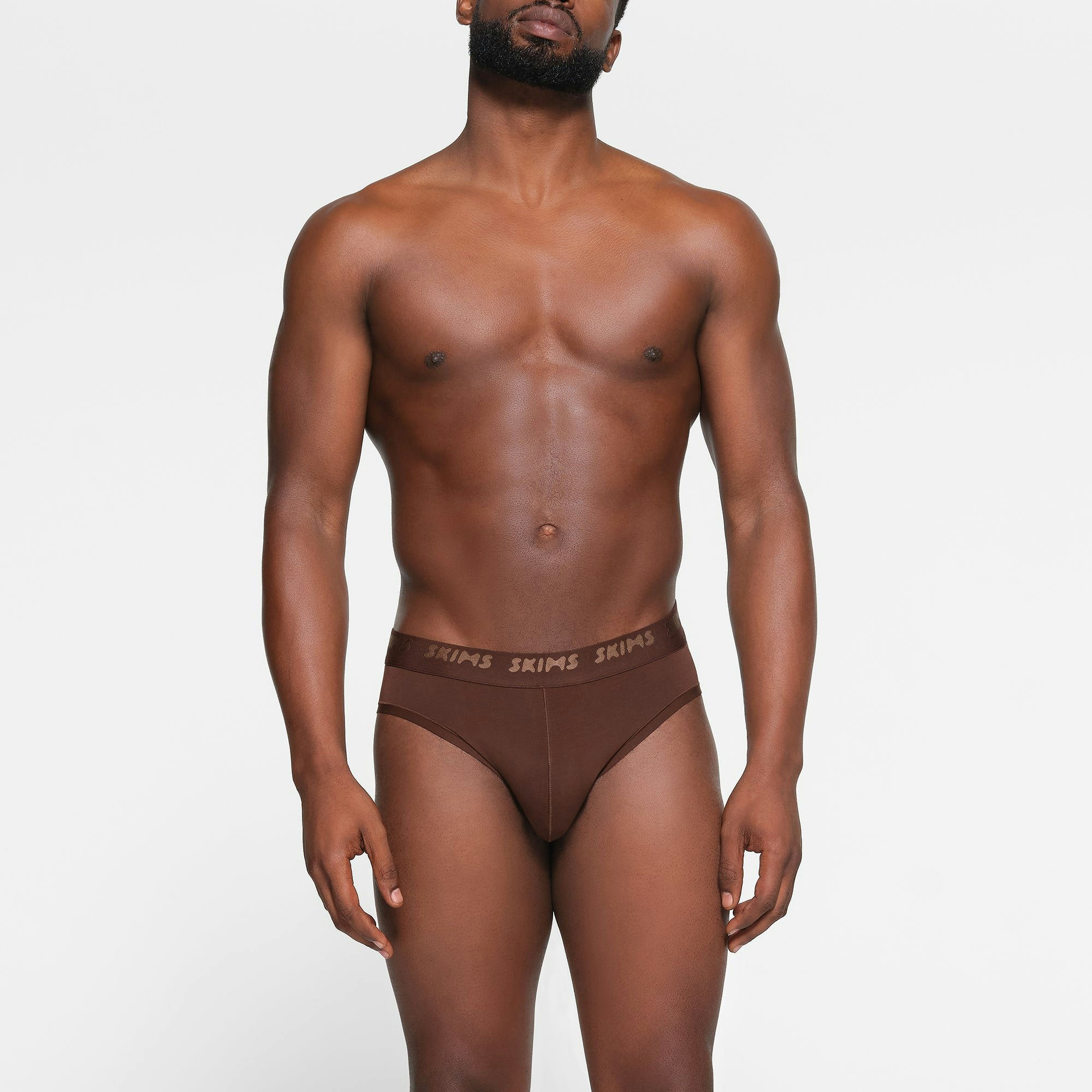 SKIMS STRETCH MENS BRIEF 3-PACK WORN BY A MODEL IN FRONT VIEW