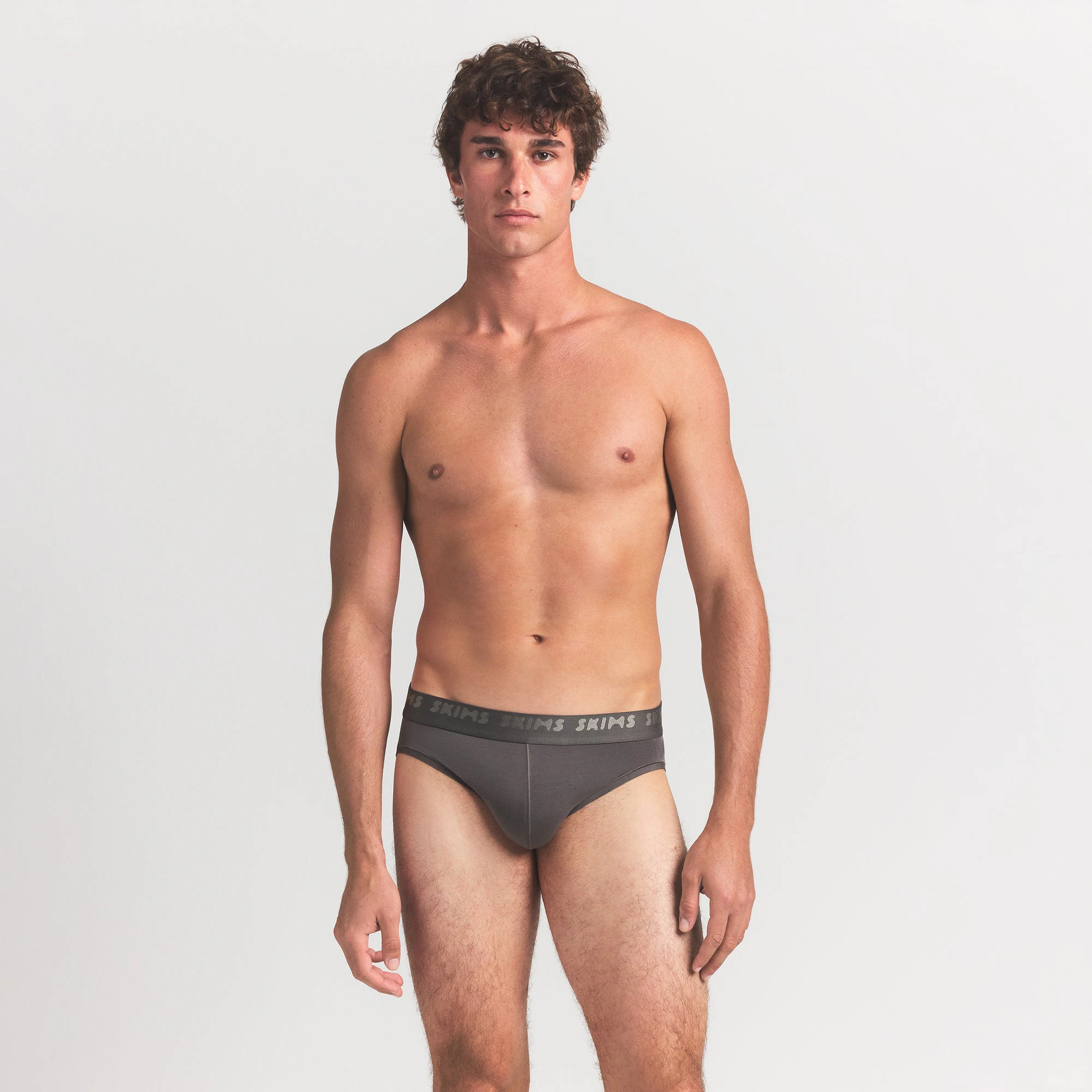 SKIMS STRETCH MENS BRIEF 3-PACK | GUNMETAL MULTI ON A MODEL FRONT VIEW