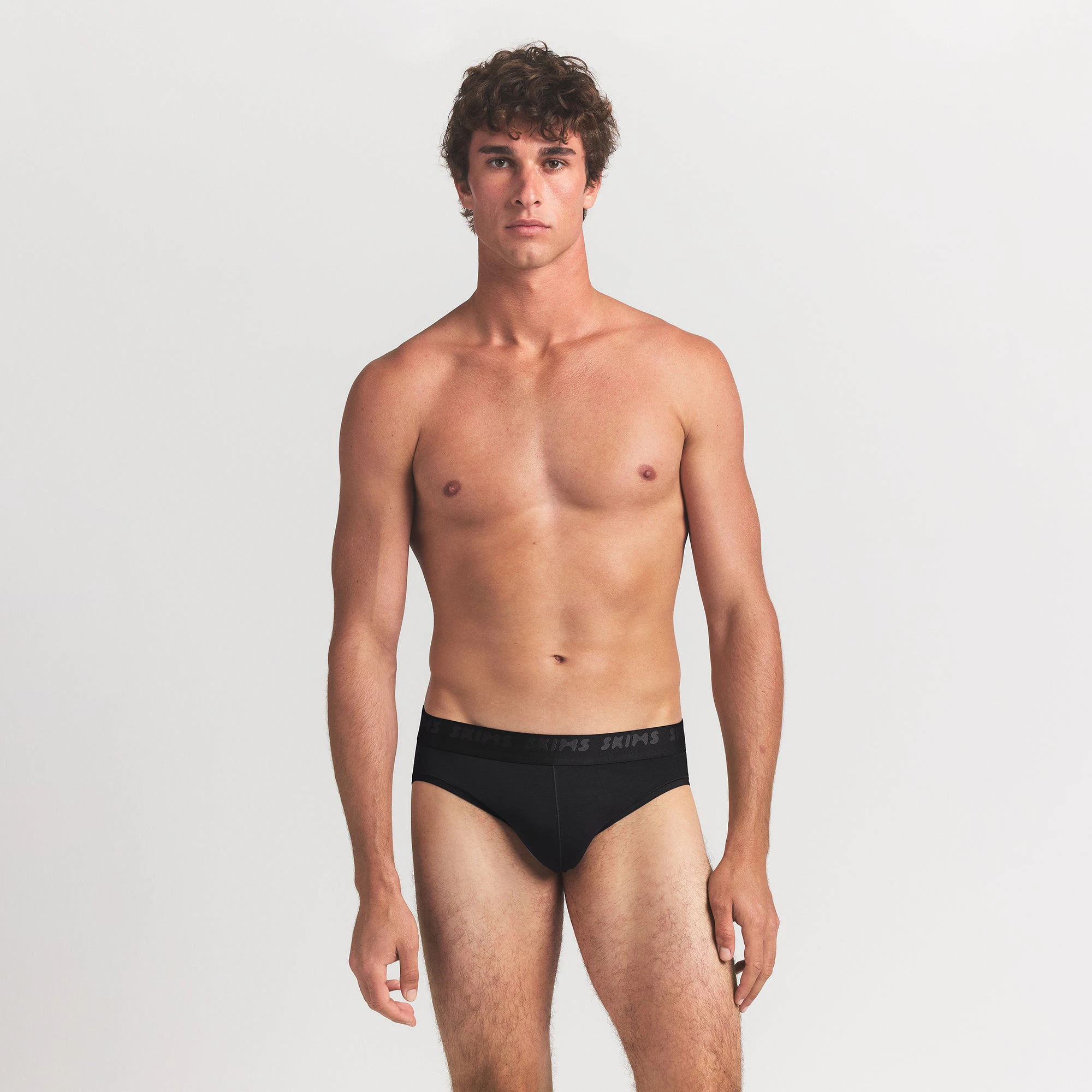 SKIMS STRETCH MENS BRIEF 3-PACK | GUNMETAL MULTI ON A MODEL FRONT VIEW