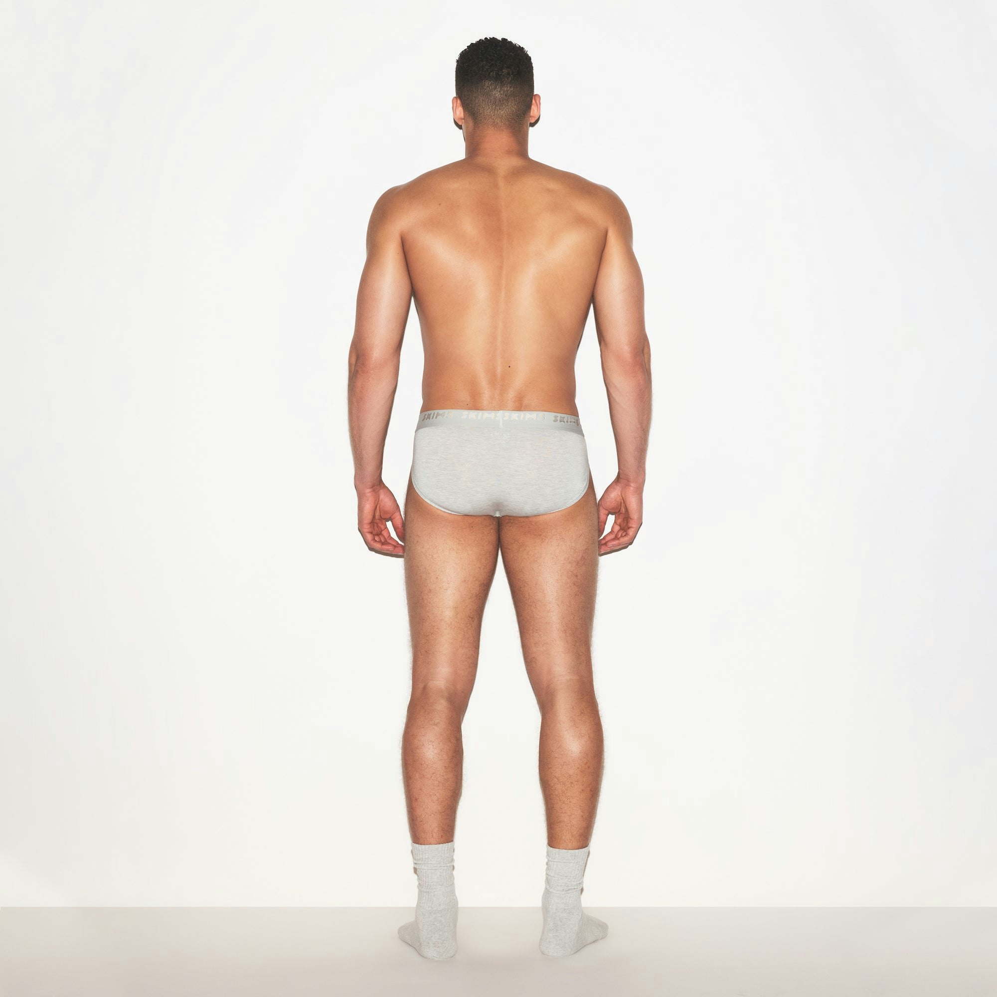 SKIMS STRETCH MENS BRIEF 3-PACK | LAUREL MULTI ON A MODEL FRONT VIEW | FOCUS: 0.0, 1.0, 0.9