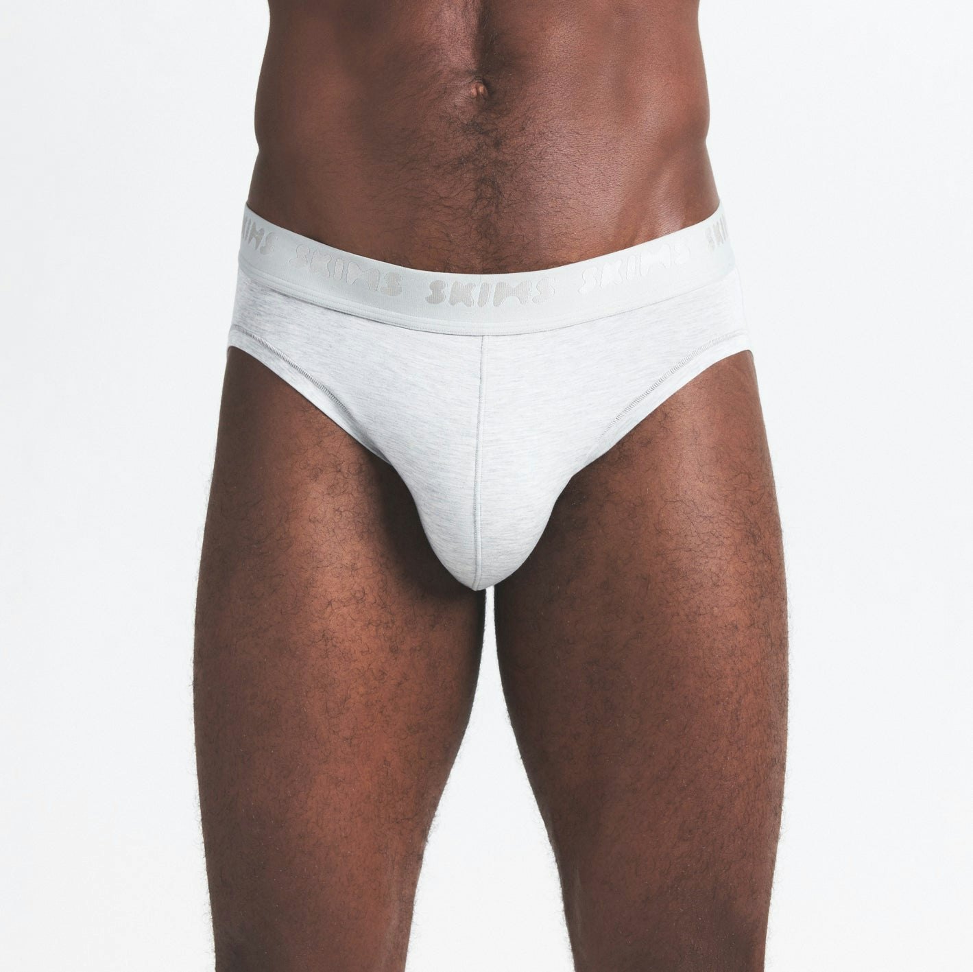 SKIMS STRETCH MENS BRIEF 3-PACK | WOOD MULTI ON A MODEL SIDE VIEW @ | FOCUS: 0.0, 1.0, 0.9