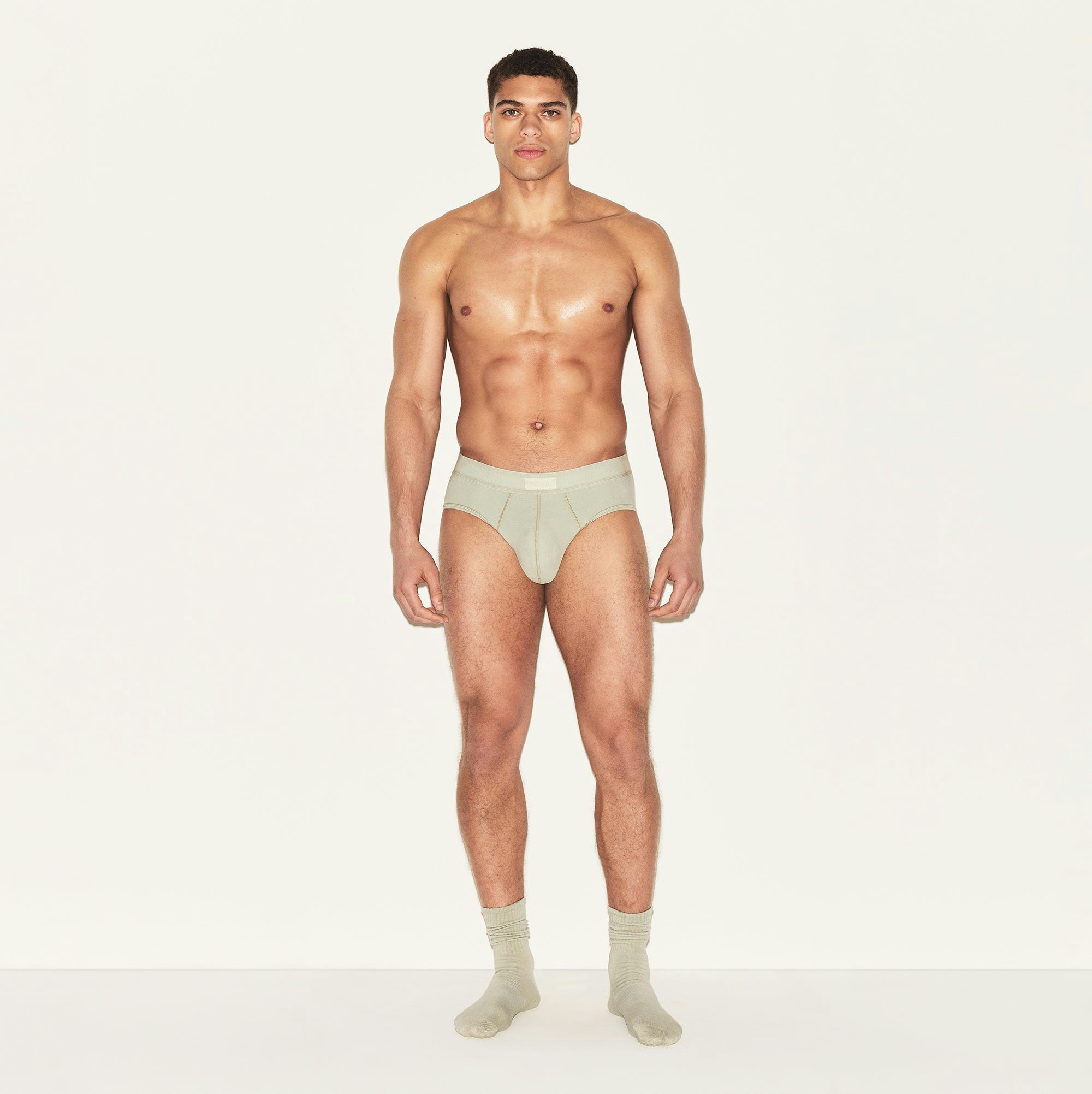 SKIMS COTTON MENS BRIEF 3-PACK | ARMY MULTI ON A MODEL FRONT VIEW | FOCUS: 0.0, 1.0, 0.9