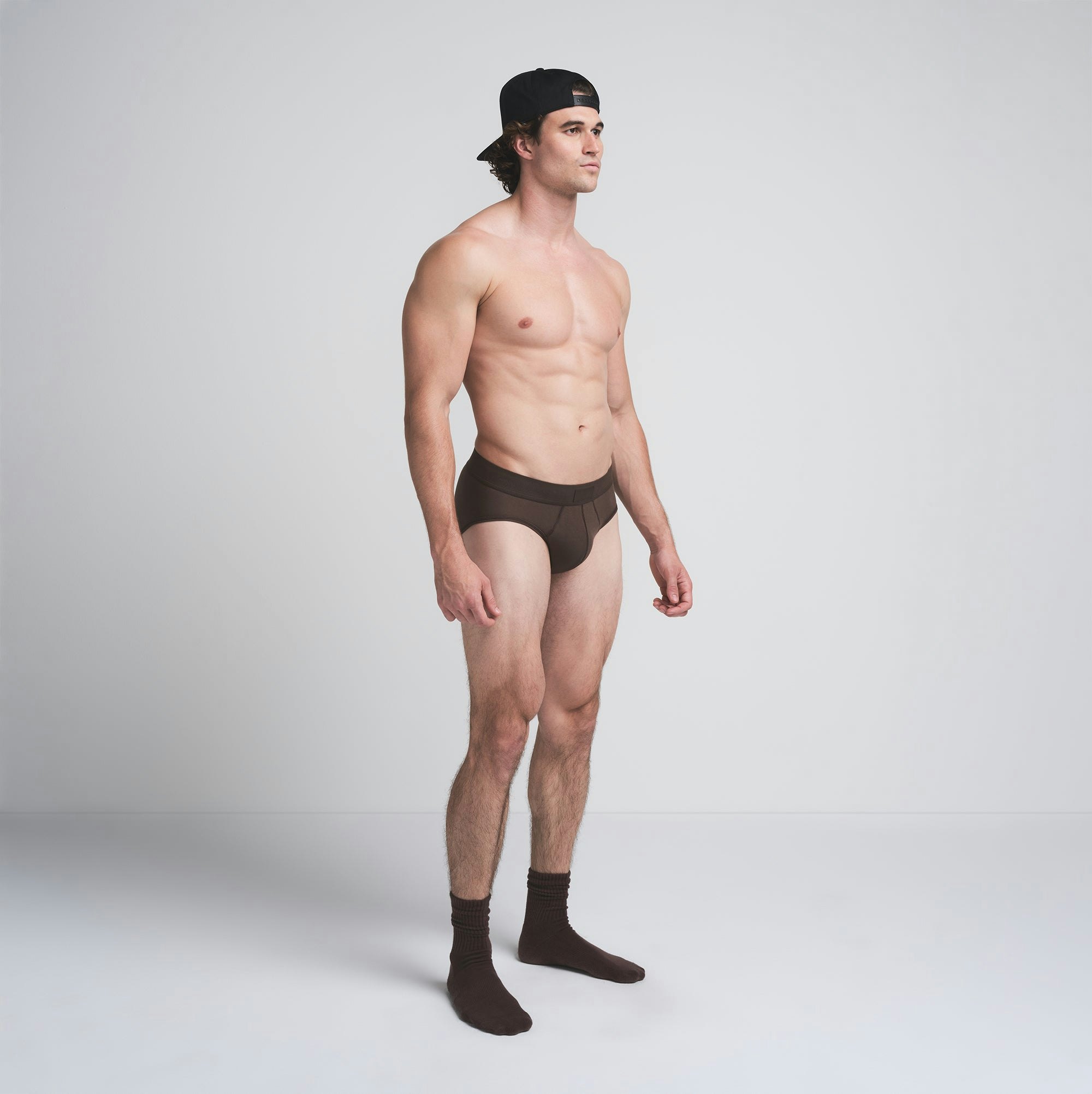 SKIMS COTTON MENS BRIEF 3-PACK | DARK SEPIA MULTI ON A MODEL SIDE VIEW