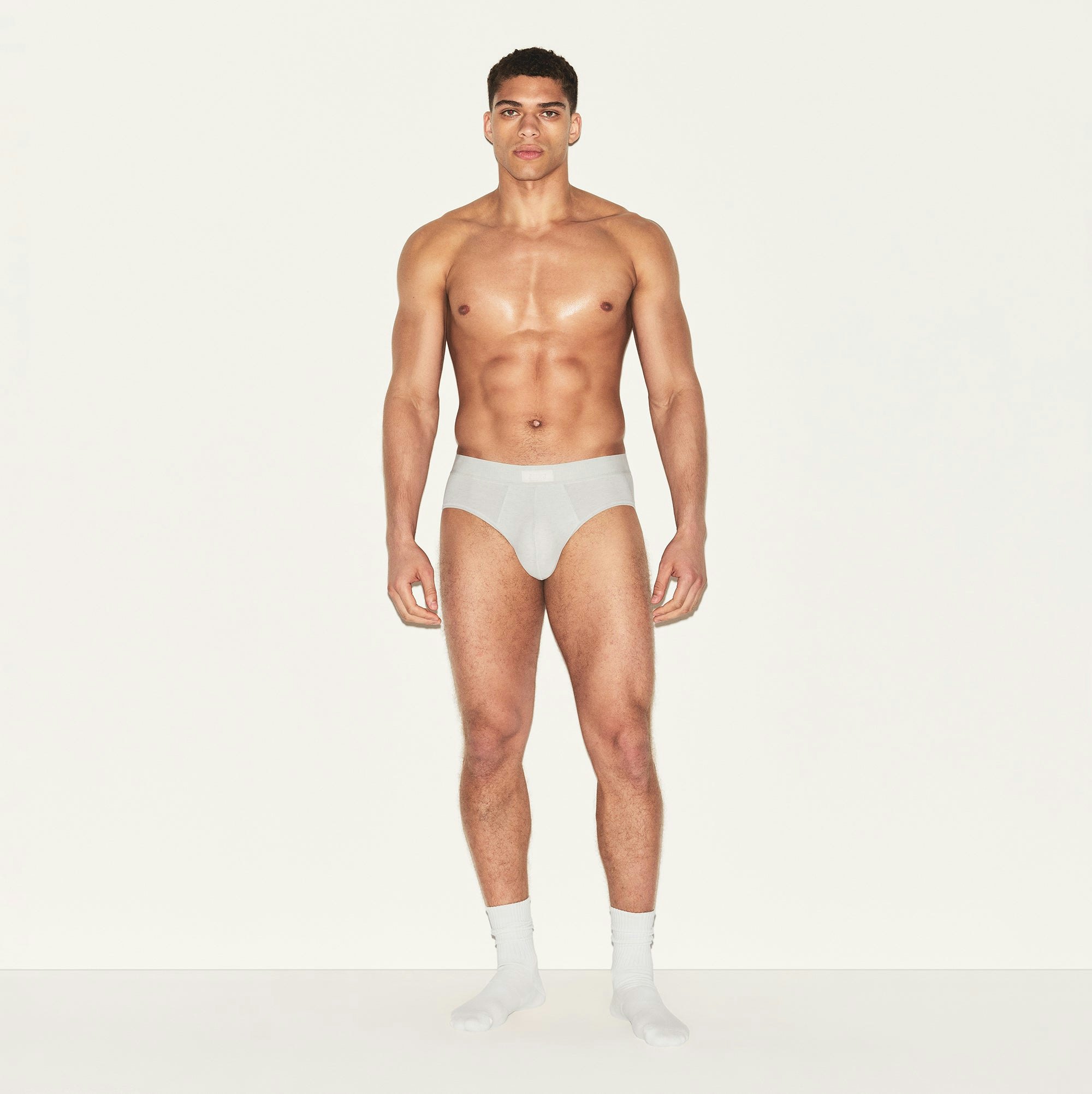 SKIMS COTTON MENS BRIEF 3-PACK | HEATHER MULTI ON A MODEL FRONT VIEW | FOCUS: 0.0, 1.0, 0.9