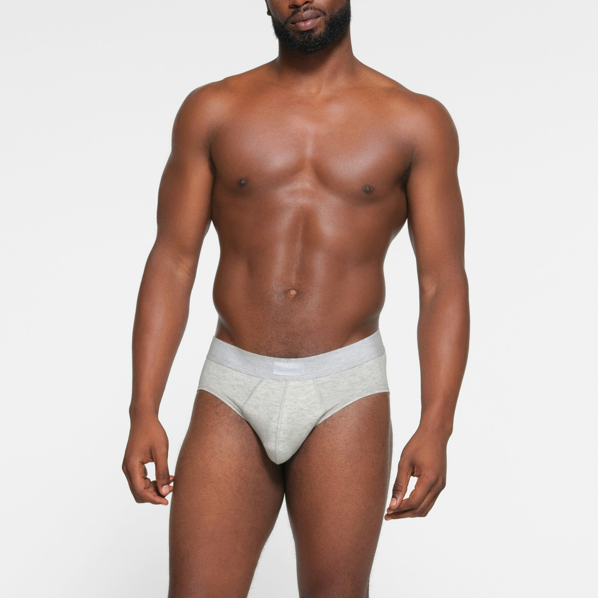 SKIMS COTTON MENS BRIEF 3-PACK WORN BY A MODEL IN FRONT VIEW