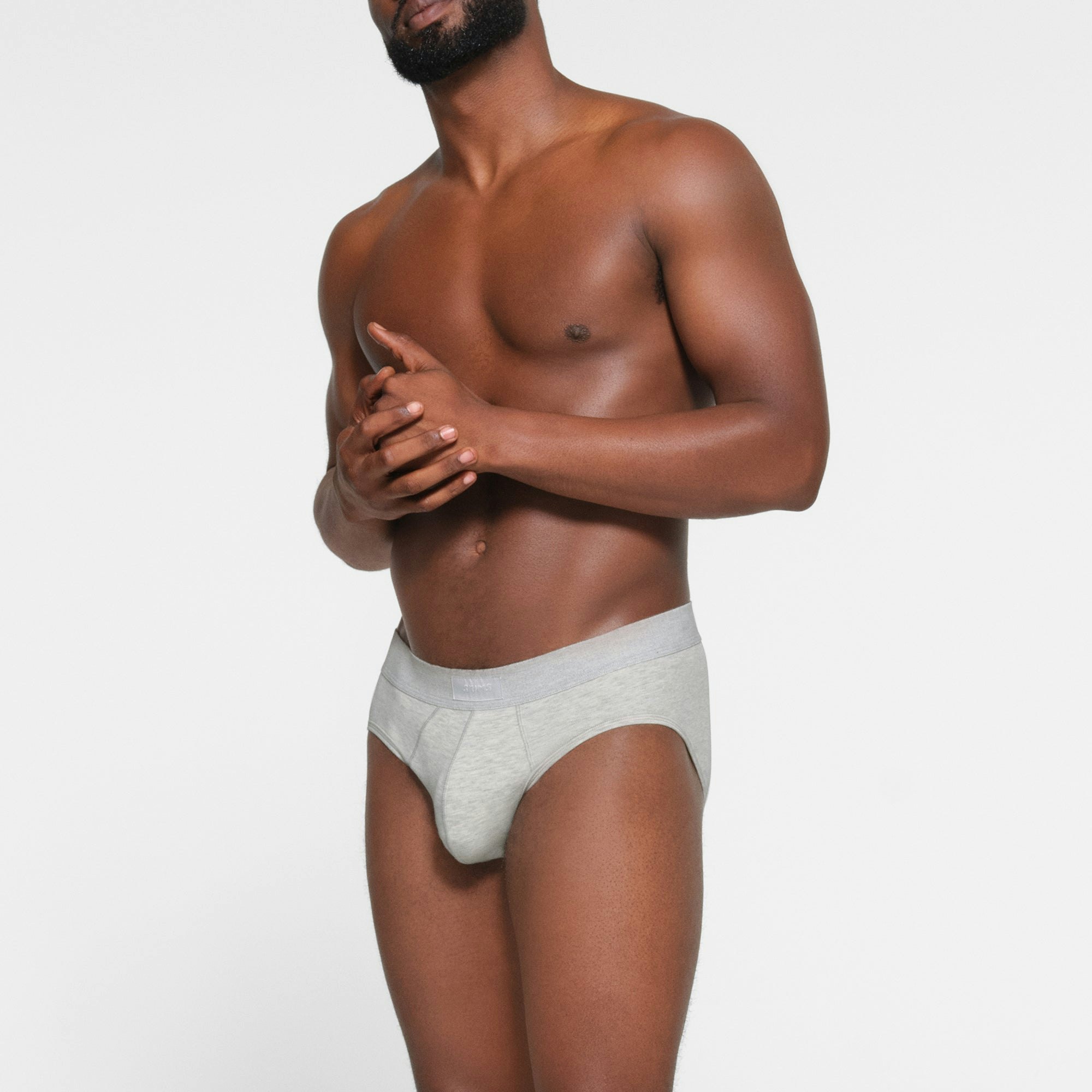 SKIMS COTTON MENS BRIEF 3-PACK WORN BY A MODEL IN SIDE VIEW