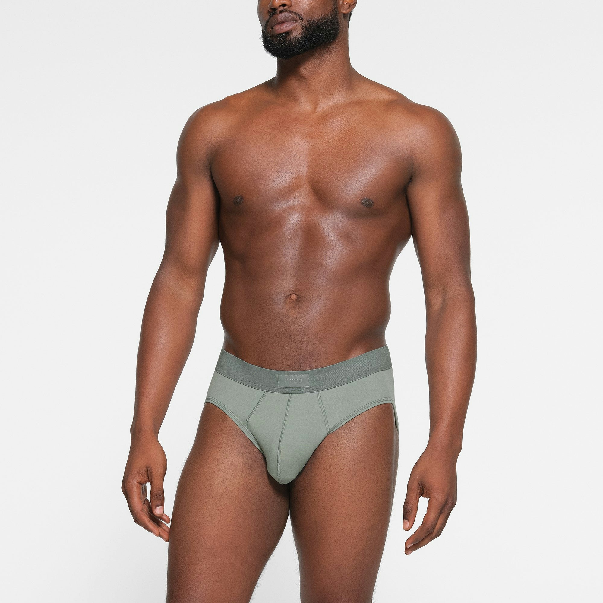 SKIMS COTTON MENS BRIEF 3-PACK WORN BY A MODEL IN FRONT VIEW