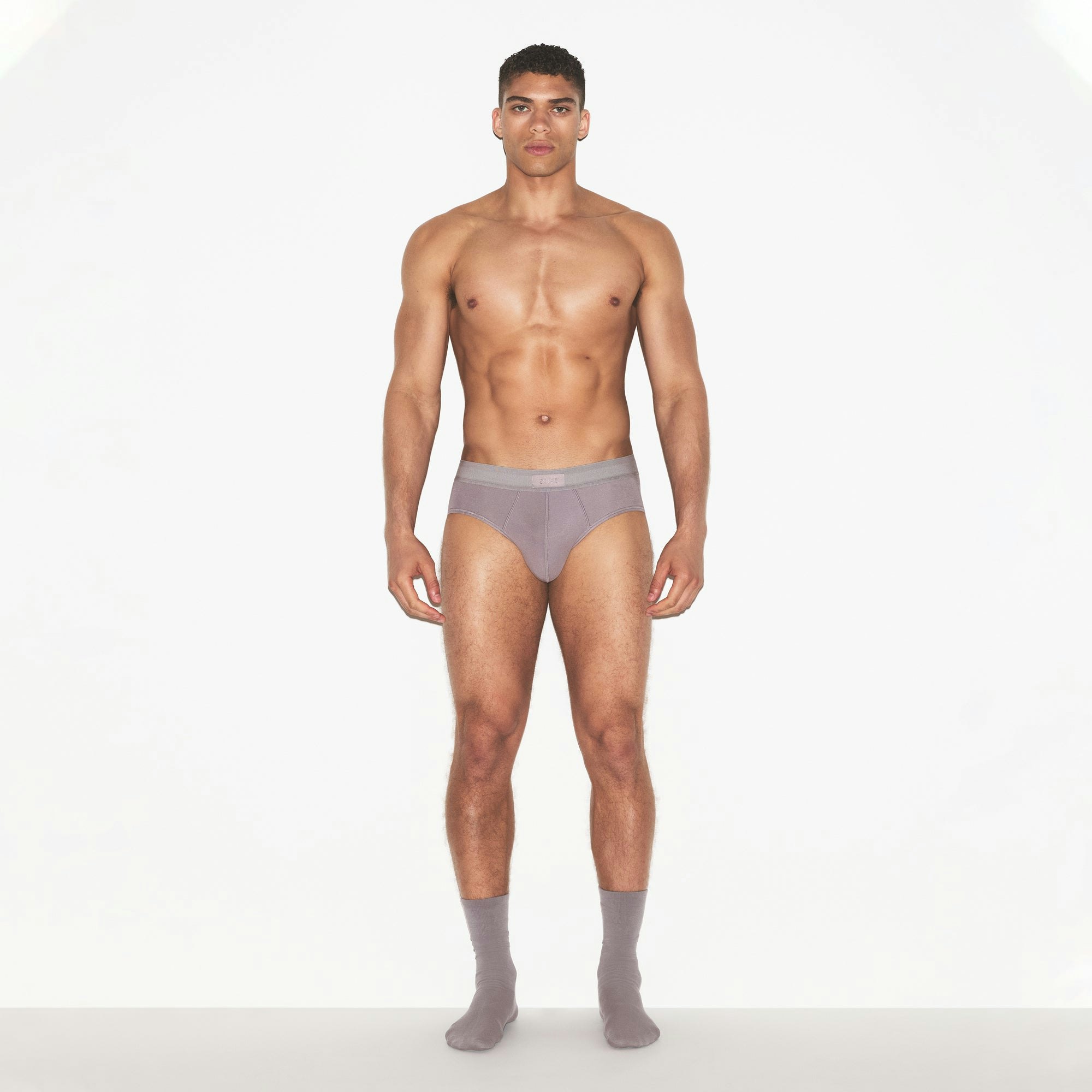 SKIMS COTTON MENS BRIEF 3-PACK | RUSSET MULTI ON A MODEL FRONT VIEW | FOCUS: 0.0, 1.0, 0.9