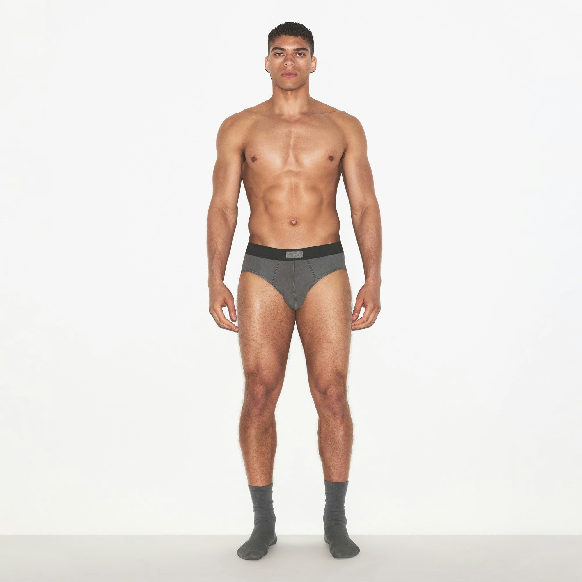 SKIMS COTTON MENS BRIEF 3-PACK | RUSSET MULTI ON A MODEL FRONT VIEW | FOCUS: 0.0, 1.0, 0.9