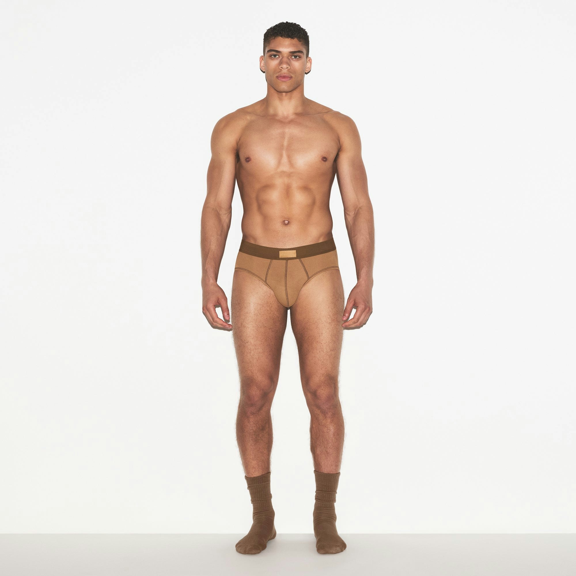 SKIMS COTTON MENS BRIEF 3-PACK | RUSSET MULTI ON A MODEL FRONT VIEW | FOCUS: 0.0, 1.0, 0.9