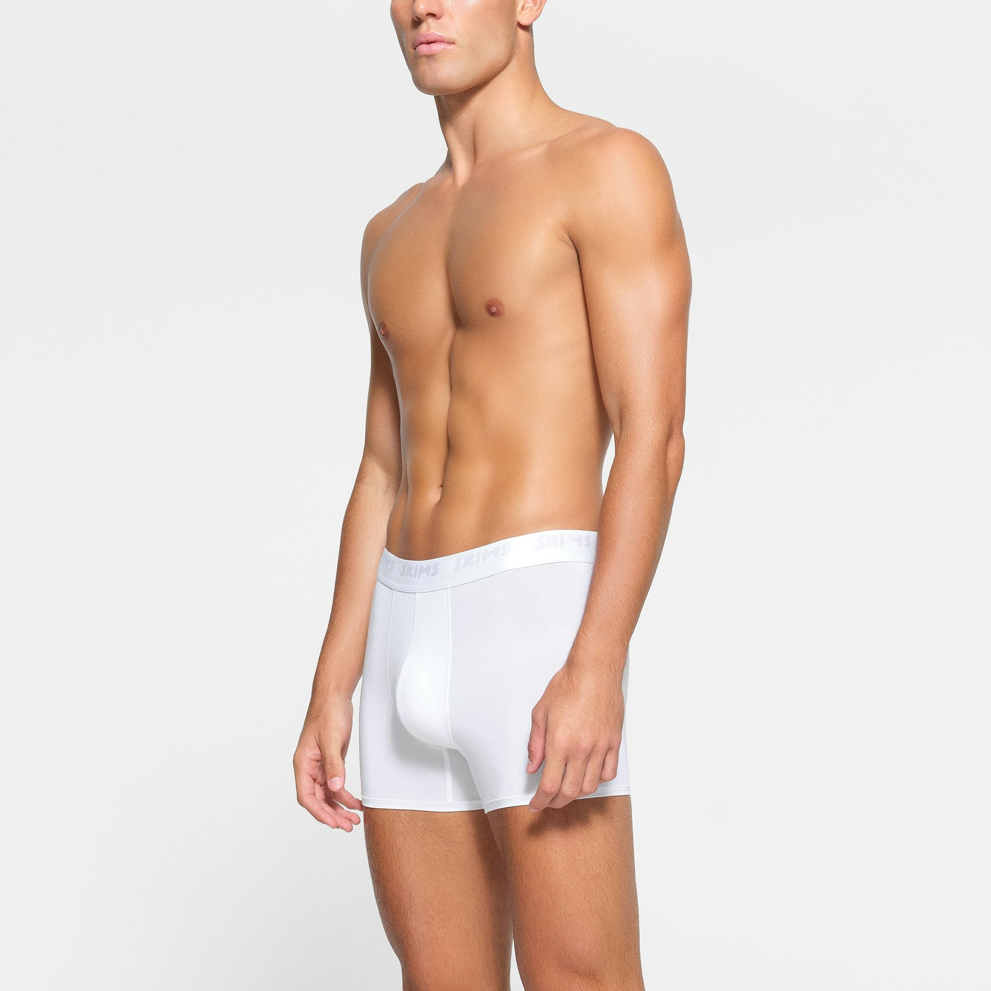 SKIMS STRETCH MENS 3" BOXER BRIEF 3-PACK WORN BY A MODEL IN SIDE VIEW