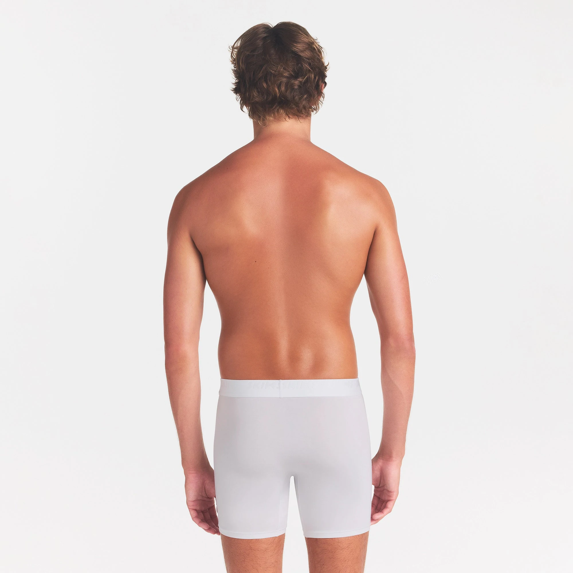 SKIMS STRETCH MENS 3" BOXER BRIEF | CHALK ON A MODEL BACK VIEW