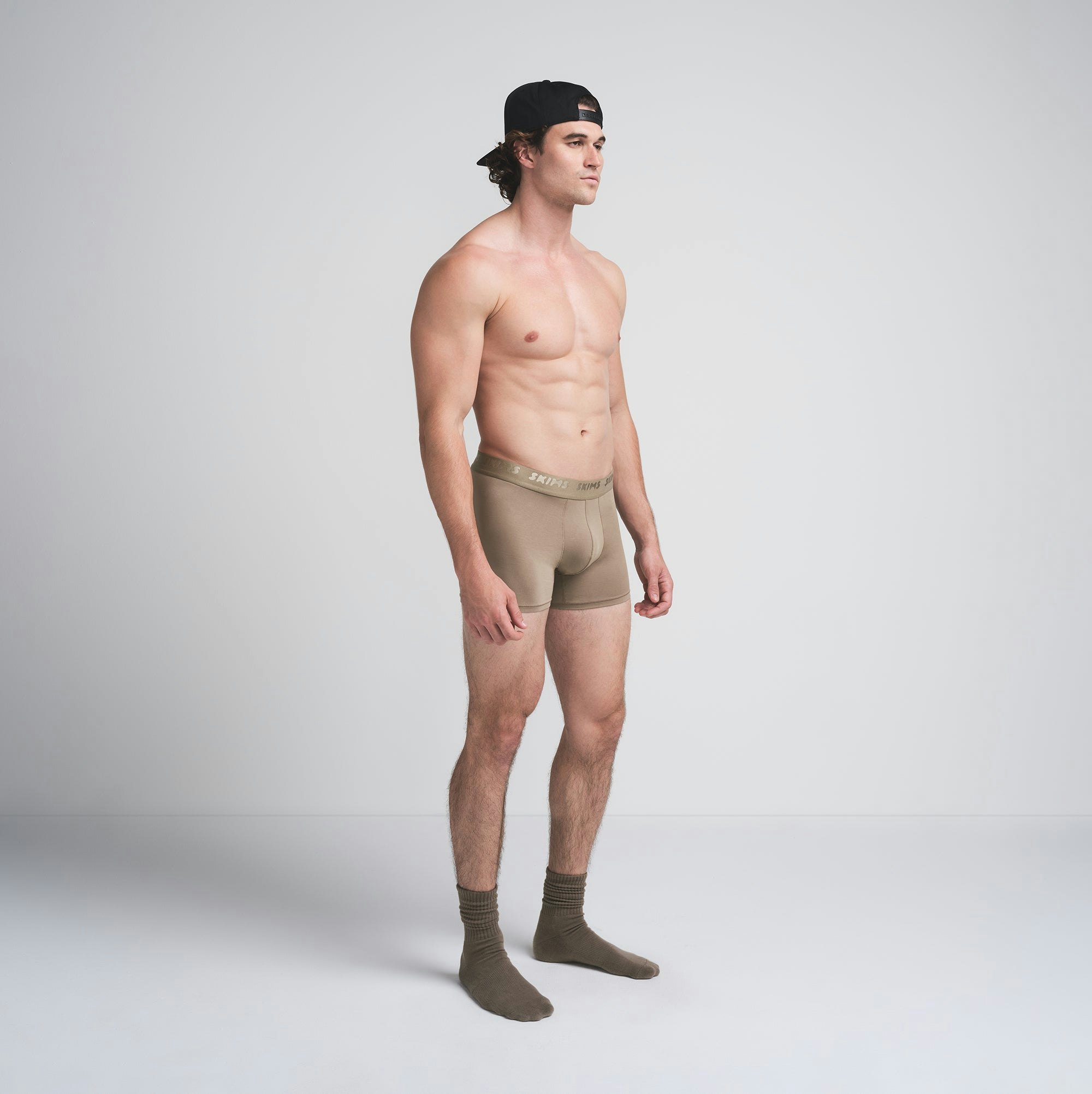 SKIMS STRETCH MENS 3" BOXER BRIEF | DESERT ON A MODEL SIDE VIEW