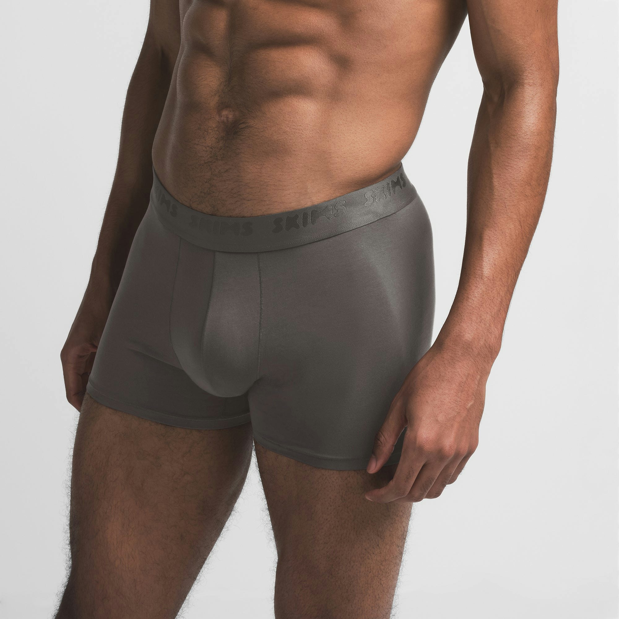 SKIMS STRETCH MENS 3" BOXER BRIEF | GUNMETAL ON A MODEL SIDE VIEW @ | FOCUS: 0.9, 0.1, 0.7