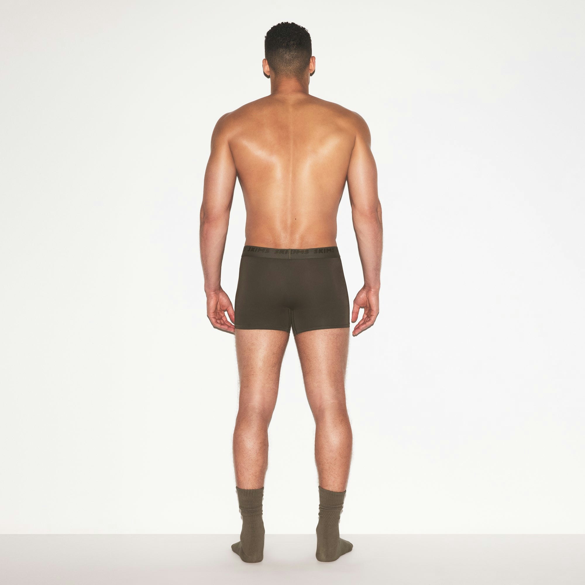 SKIMS STRETCH MENS 3 INCH BOXER BRIEF | LODEN ON A MODEL FRONT VIEW @ | FOCUS: 0.0, 1.0, 0.9