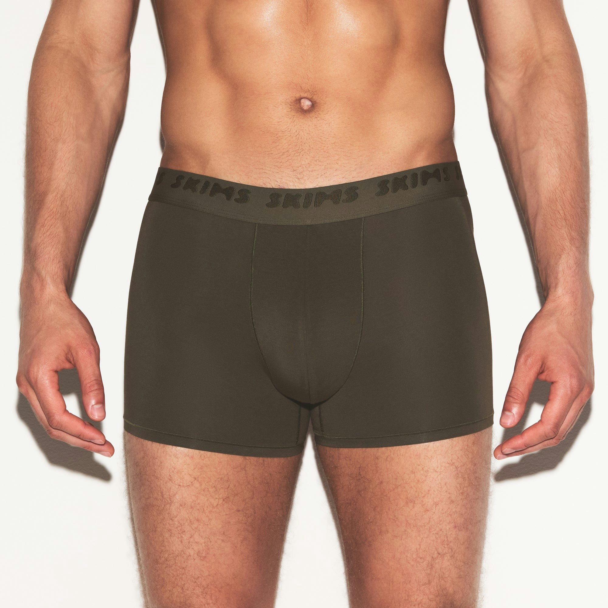 SKIMS STRETCH MENS 3 INCH BOXER BRIEF | LODEN ON A MODEL SIDE VIEW @ | FOCUS: 0.0, 1.0, 0.9