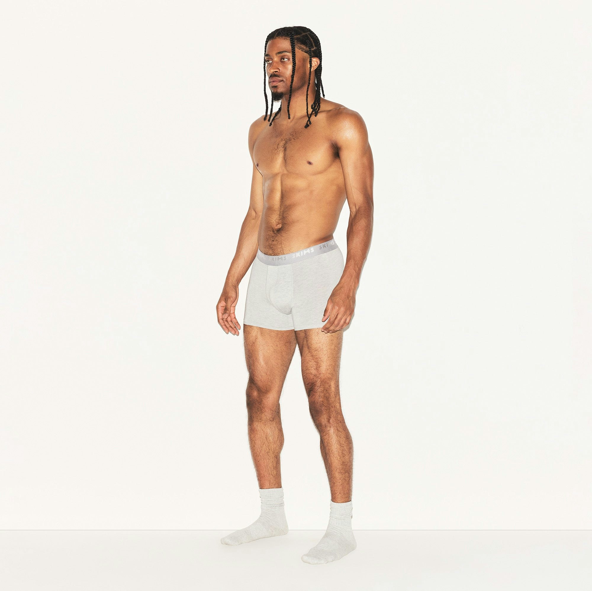 SKIMS STRETCH MENS 3" BOXER BRIEF | LIGHT HEATHER GREY ON A MODEL SIDE VIEW | FOCUS: 0.0, 1.0, 0.9