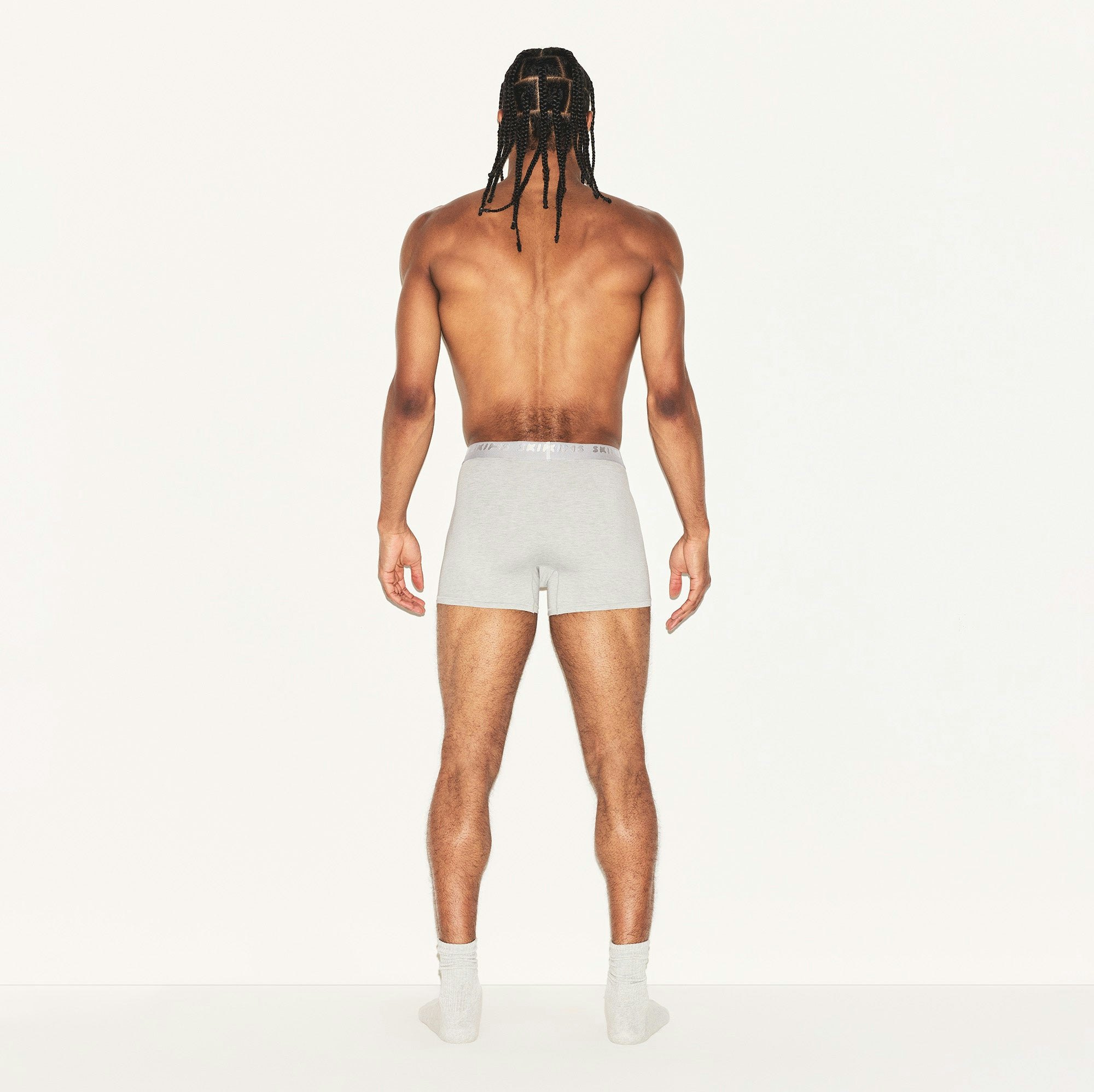 SKIMS STRETCH MENS 3" BOXER BRIEF | LIGHT HEATHER GREY ON A MODEL BACK VIEW | FOCUS: 0.0, 1.0, 0.9