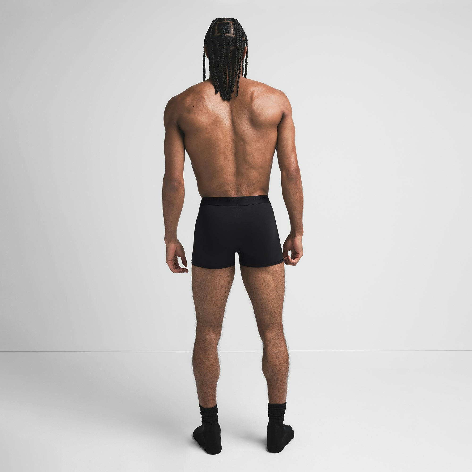 SKIMS STRETCH MENS 3" BOXER BRIEF | OBSIDIAN ON A MODEL BACK VIEW @ | FOCUS: 0.9, 0.1, 0.7